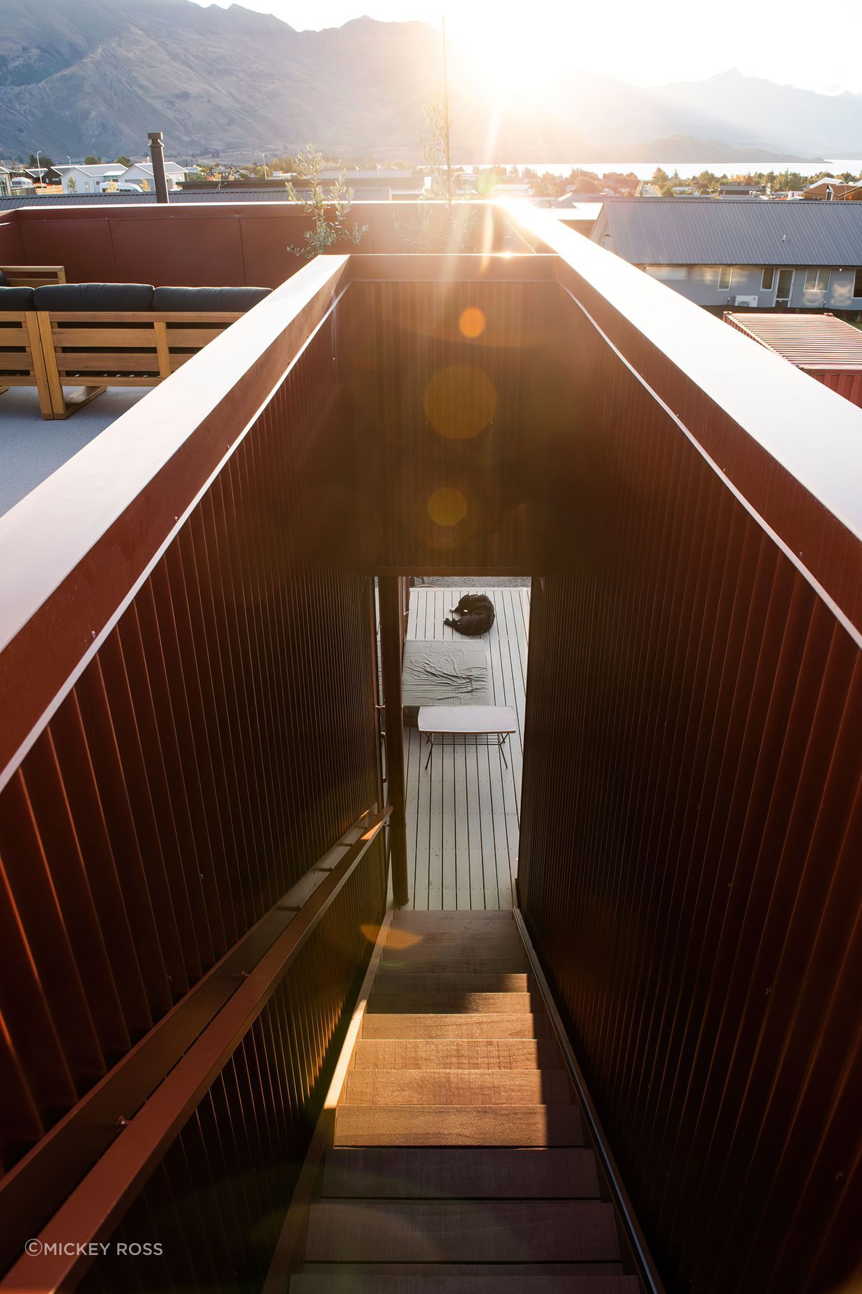 The decking around the house is Abodo Wood.