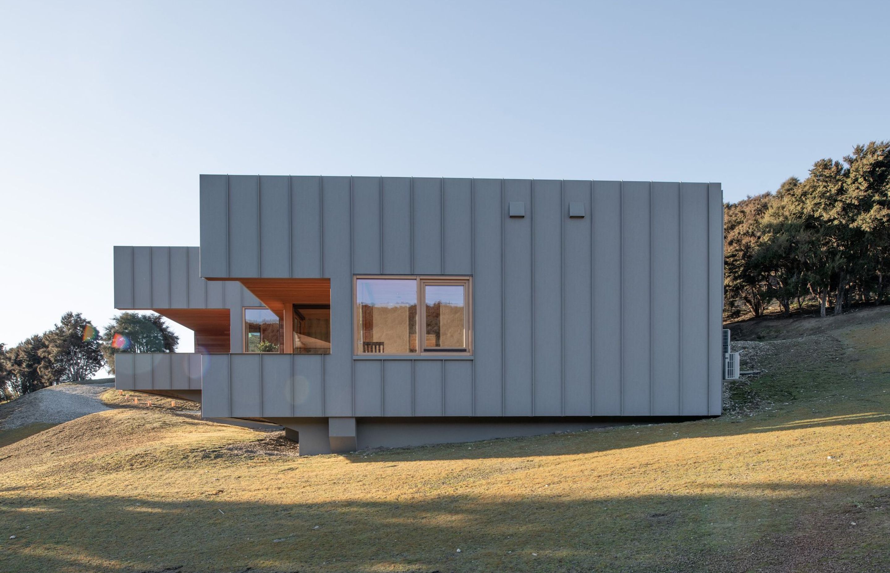 The zinc-coated aluminium will continue to patina over the time further softening the mass of the home as seen from the southern boundary.