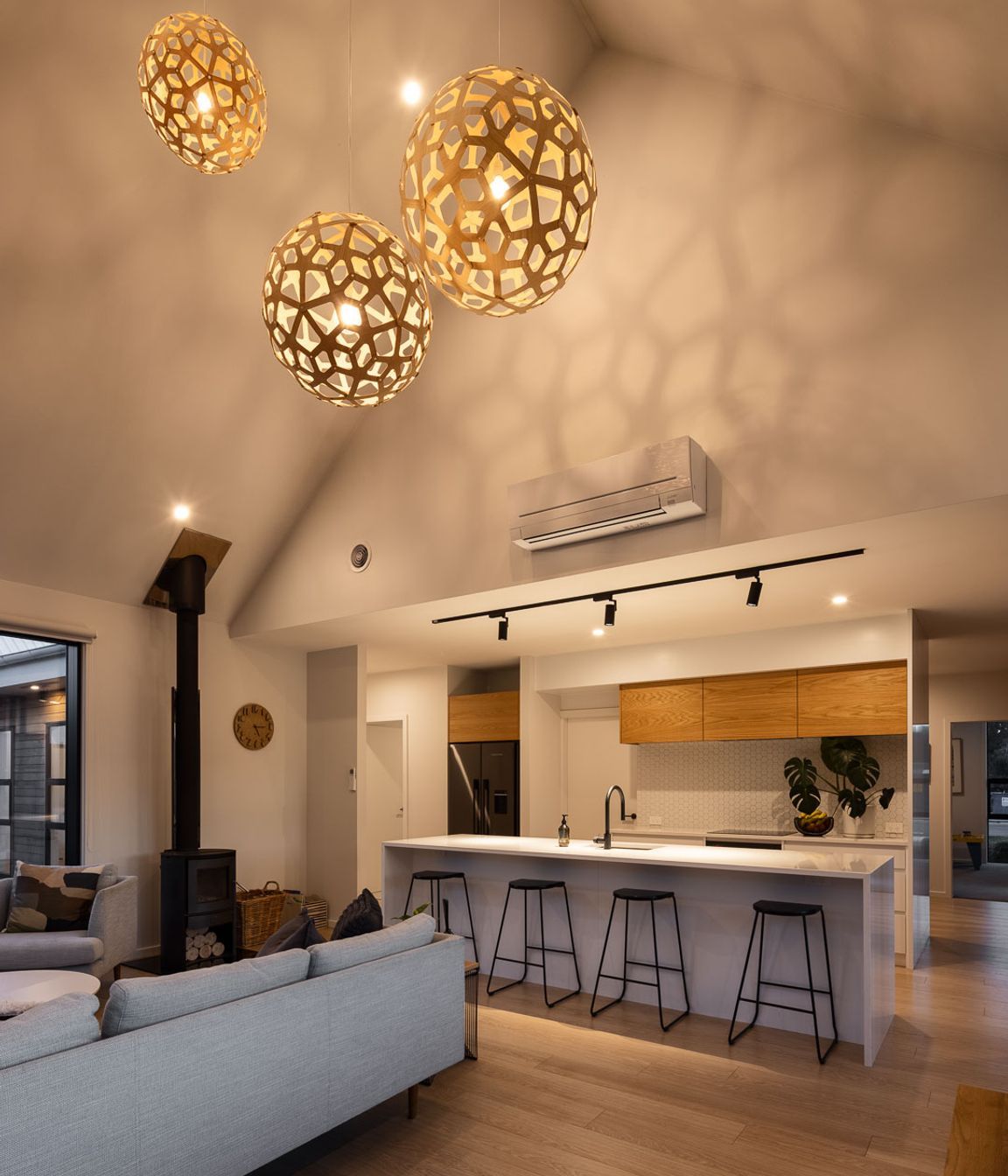 Soaring cathedral ceilings create a dramatic sense of volumetric space in the open-plan living area, which is only revealed once you step into the space.