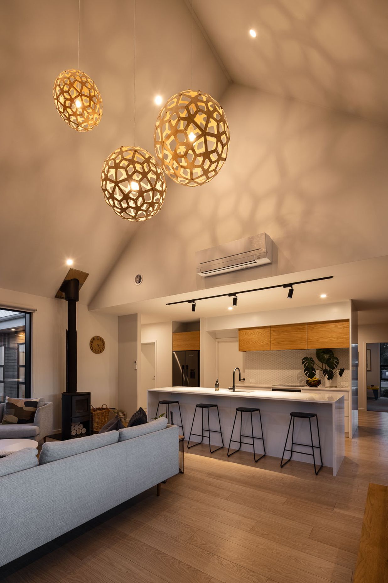 Soaring cathedral ceilings create a dramatic sense of volumetric space in the open-plan living area, which is only revealed once you step into the space.