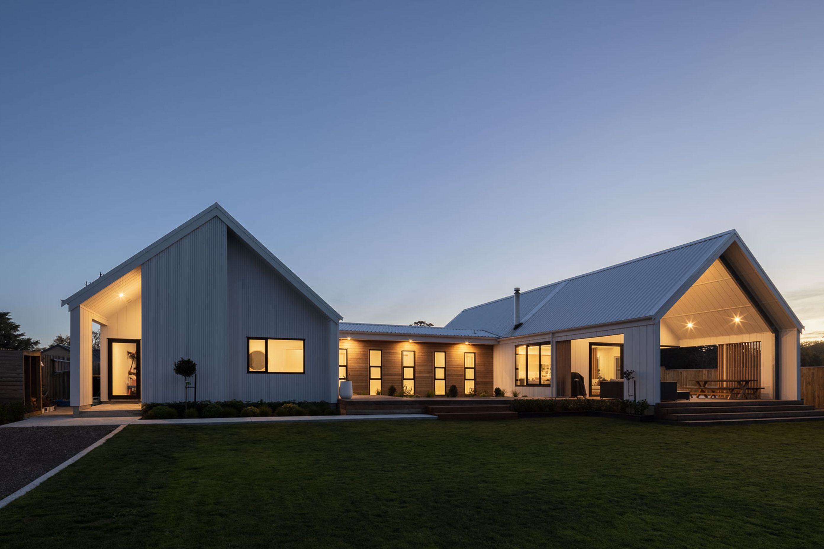 The north-facing rear facade features generous eaves and overhangs to passively manage solar gain.