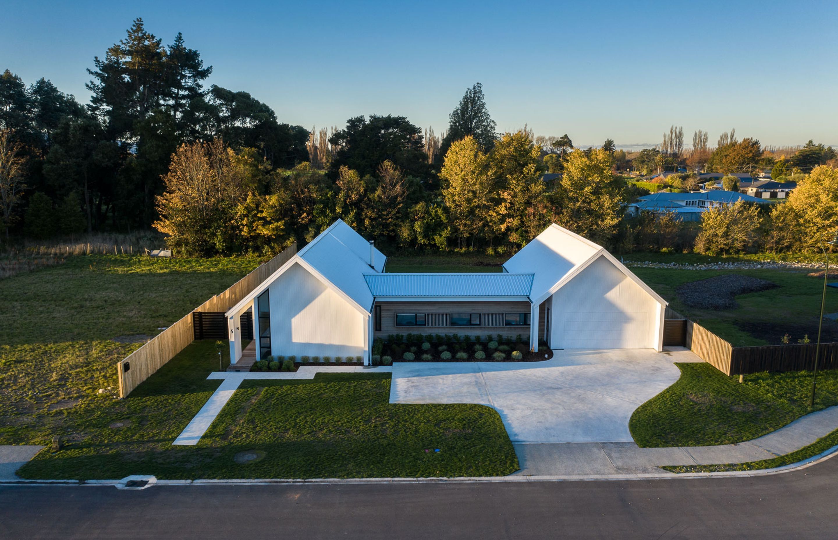 Comprising two gabled pavilions linked by a connecting element, the generously proportioned home features four bedrooms and multiple living areas.