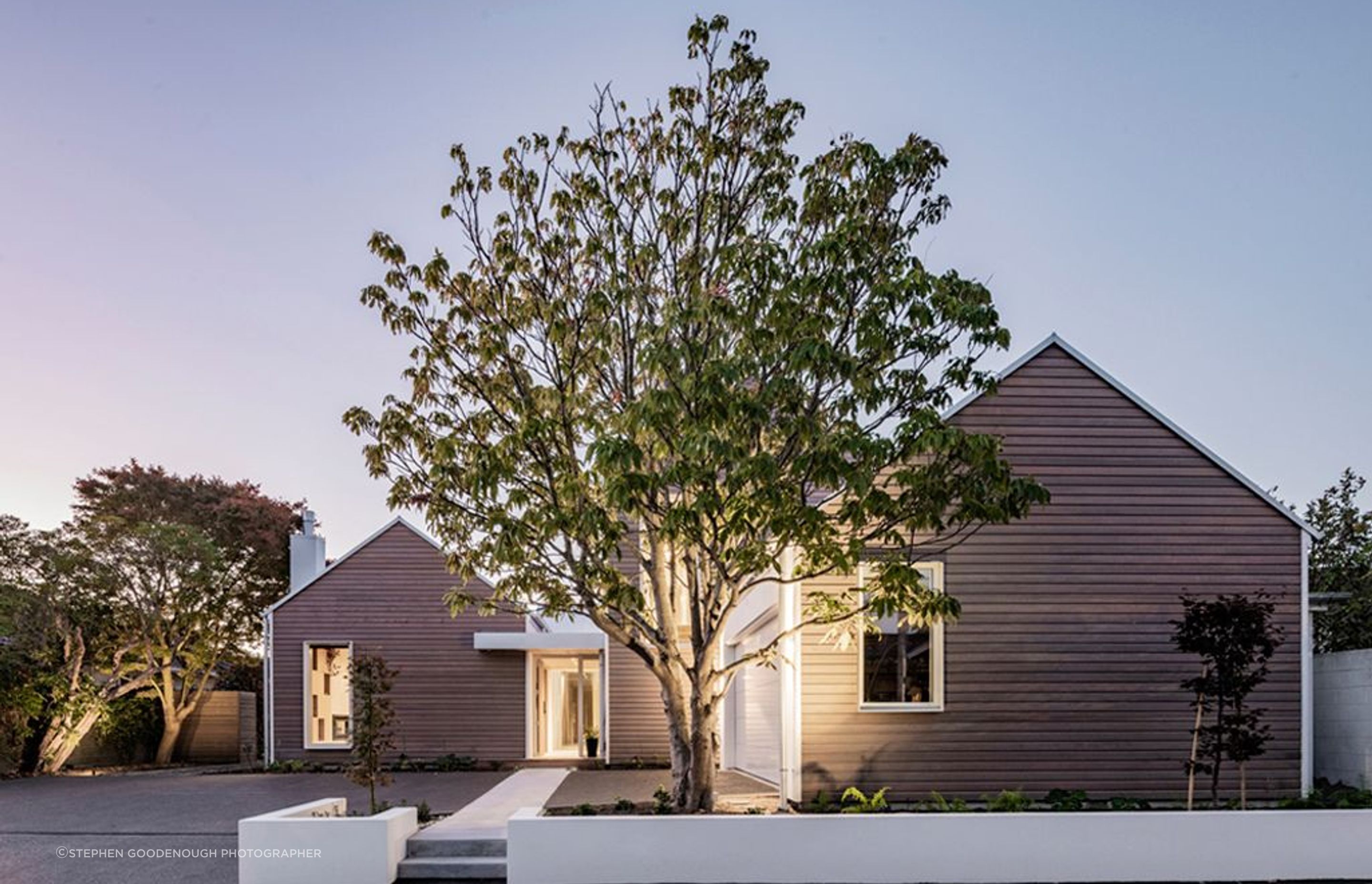 The large existing tree at the front of the home was preserved during the build.