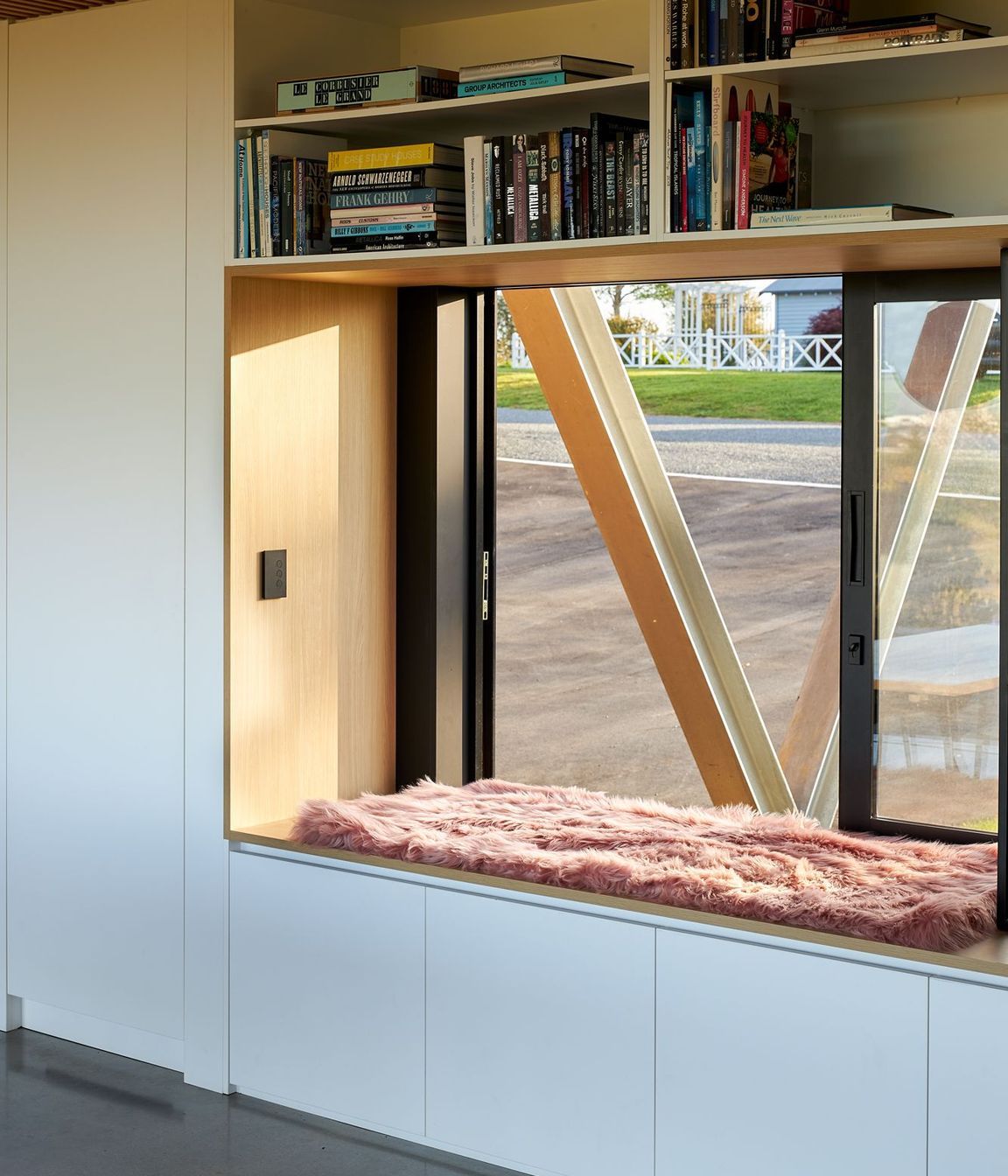 A large window with generous window seat offers a perch on the western side of the house, continuing the theme of openness and interaction with the surroundings.