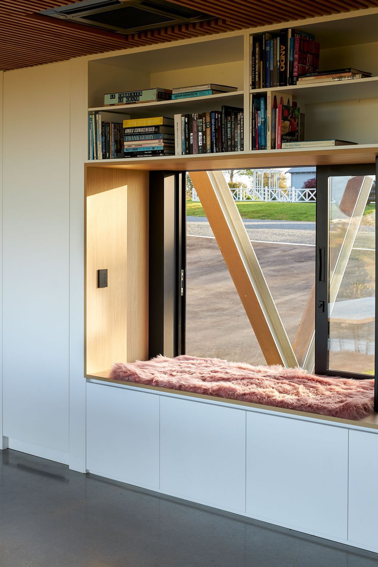 A large window with generous window seat offers a perch on the western side of the house, continuing the theme of openness and interaction with the surroundings.