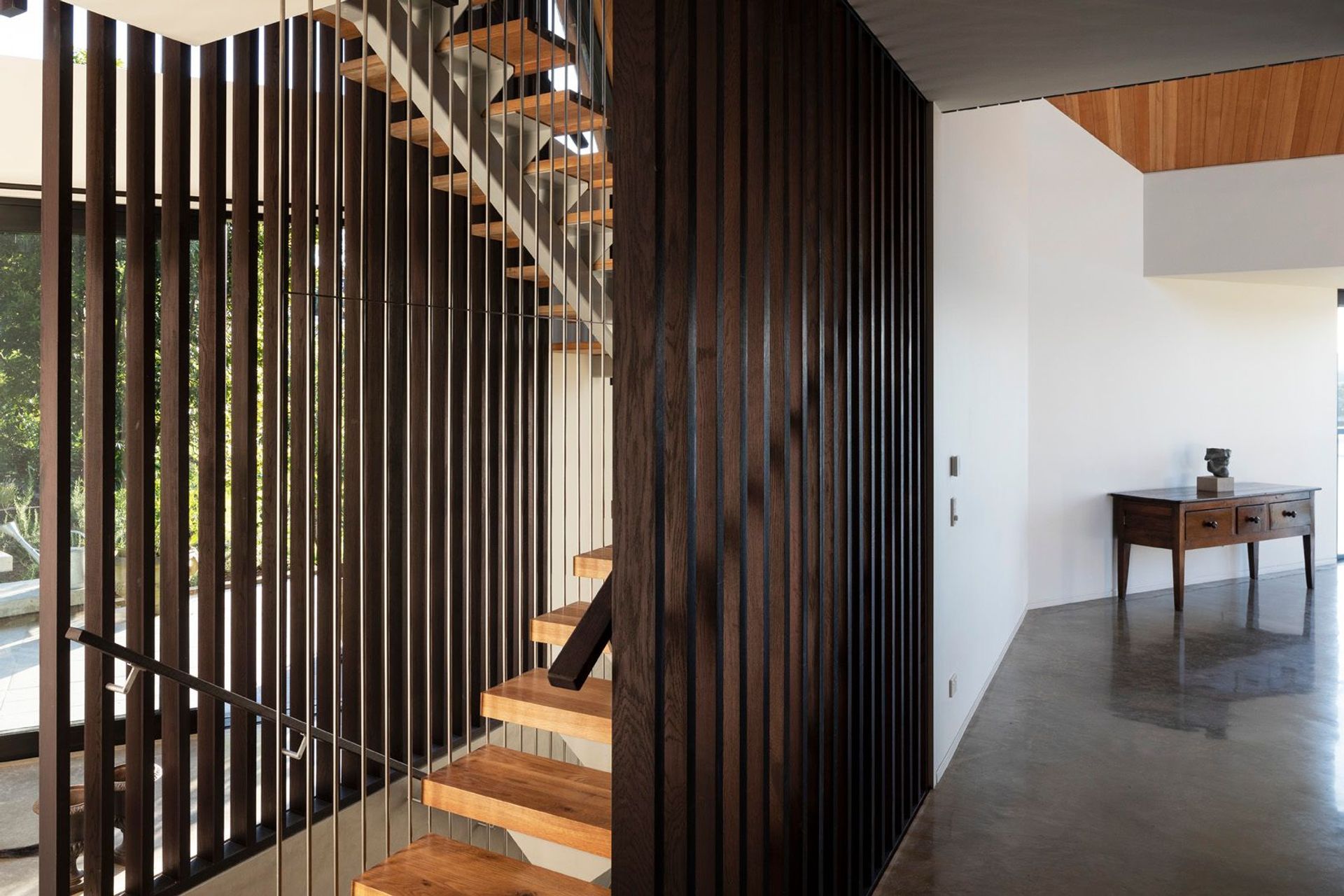 Entry to the house is situated five-metres below the main floor level. A three-storey staircase connects the entry level with the main floor as well as the mezzanine main bedroom.