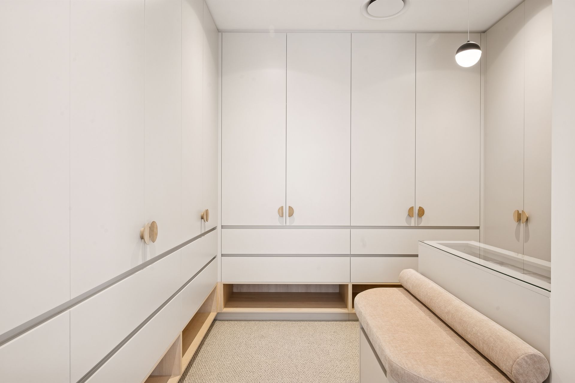 Full-height windows bring the treetops into the shower and vanity zone alike.