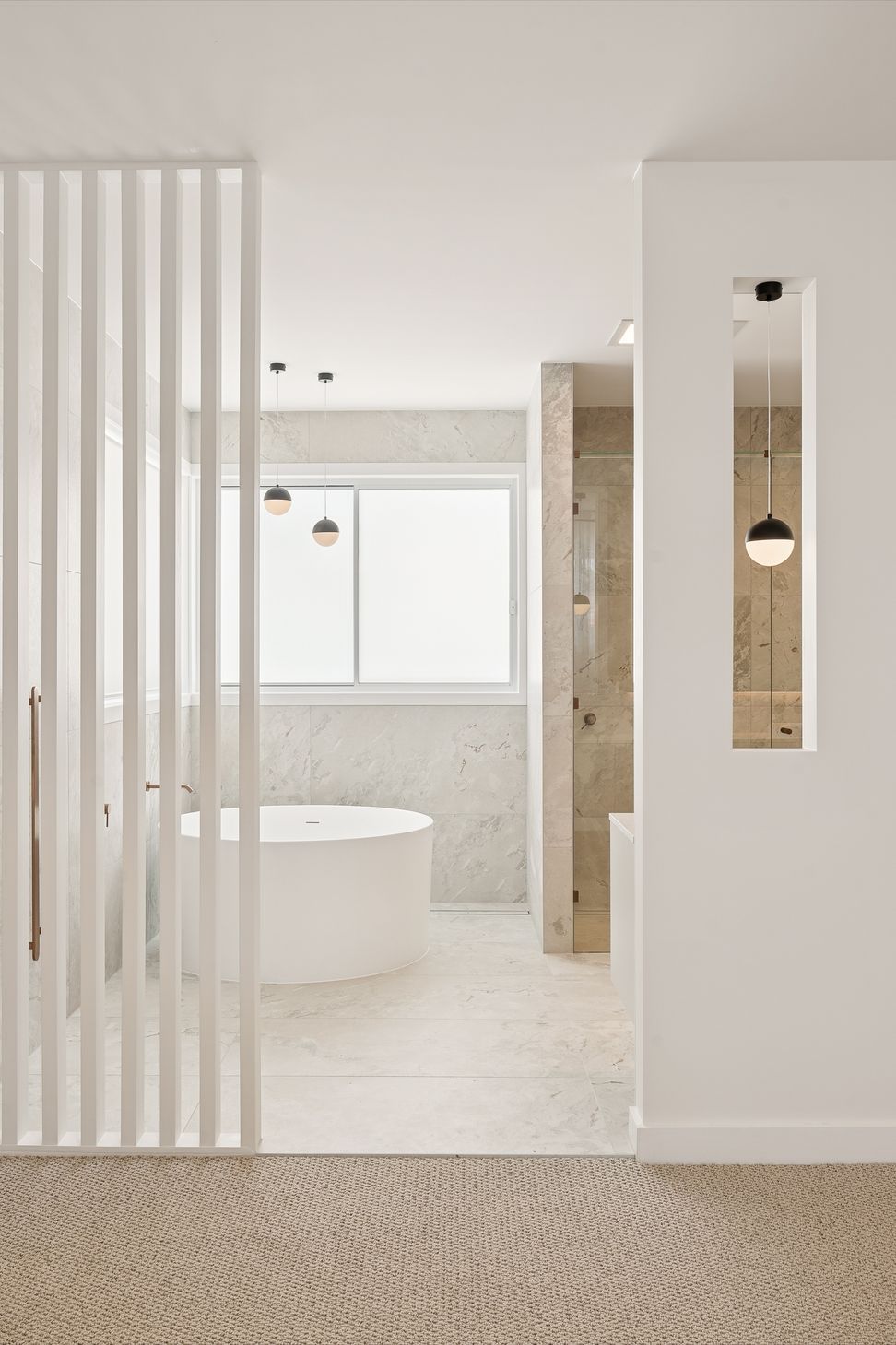 Brass tapware and warm timber joinery carry through every bathroom in the home.