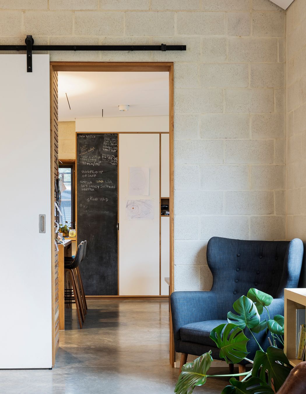 Architect-designed living room with exposed concrete block walls and polished concrete floors