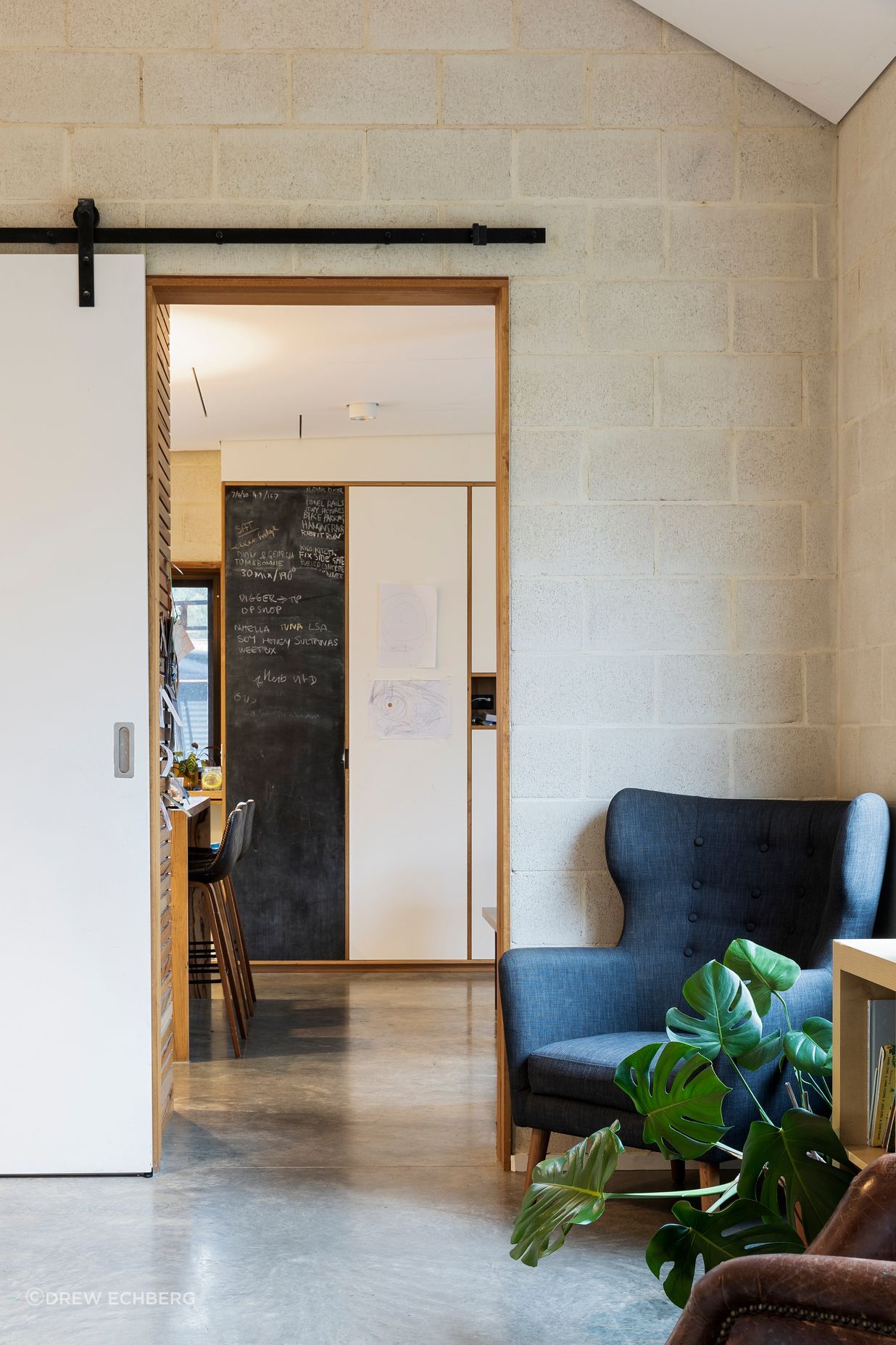 Architect-designed living room with exposed concrete block walls and polished concrete floors