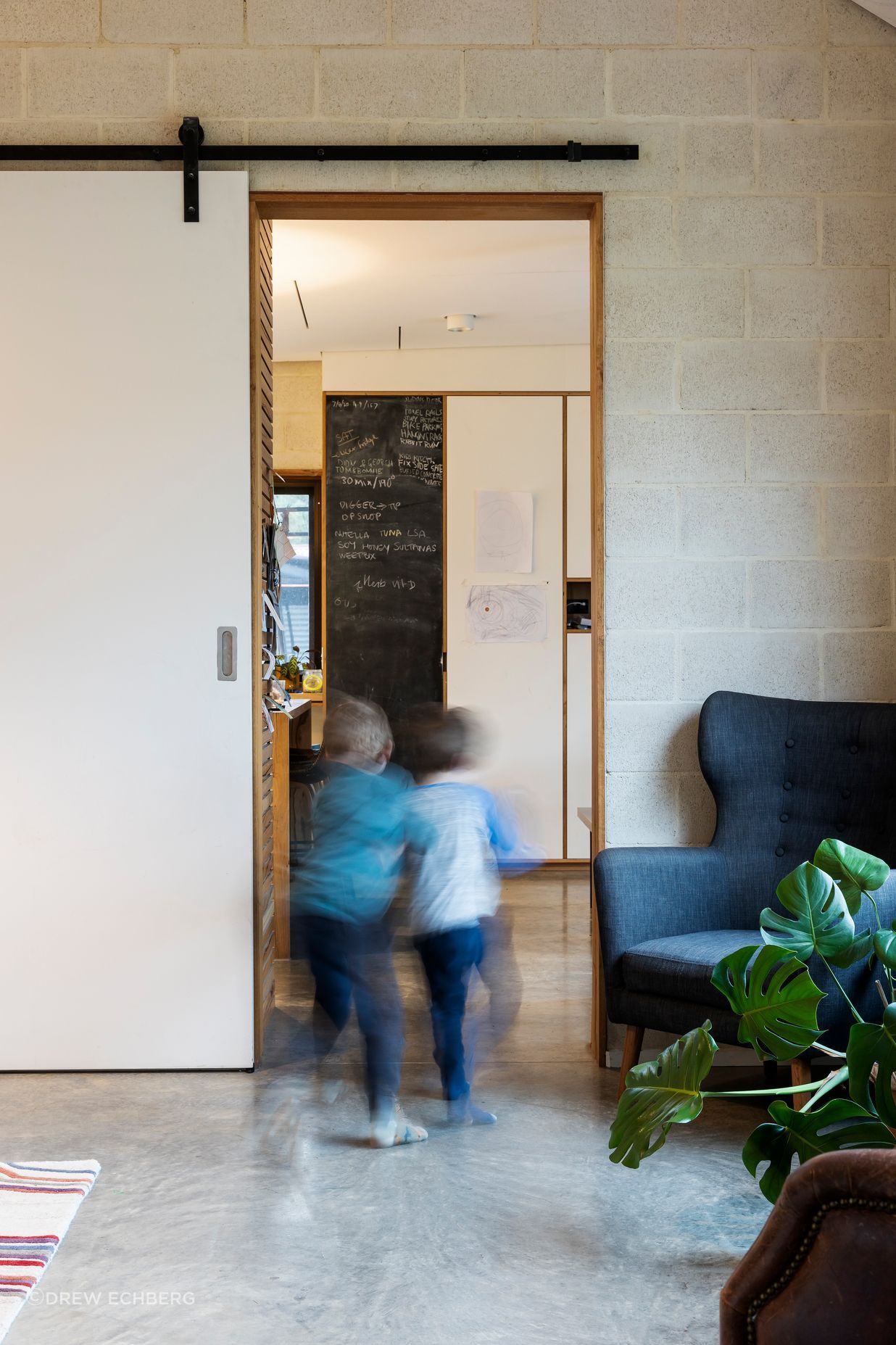Barn-style sliding doors provide acoustic and thermal separation between living areas