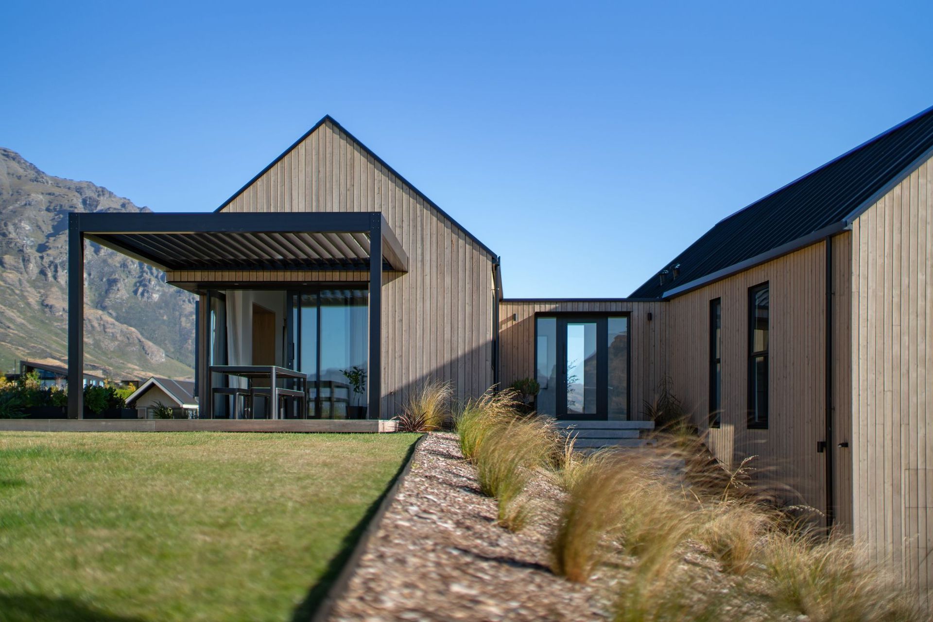 The morning sun is enjoyed from a deck spilling out form the kitchen/living space.