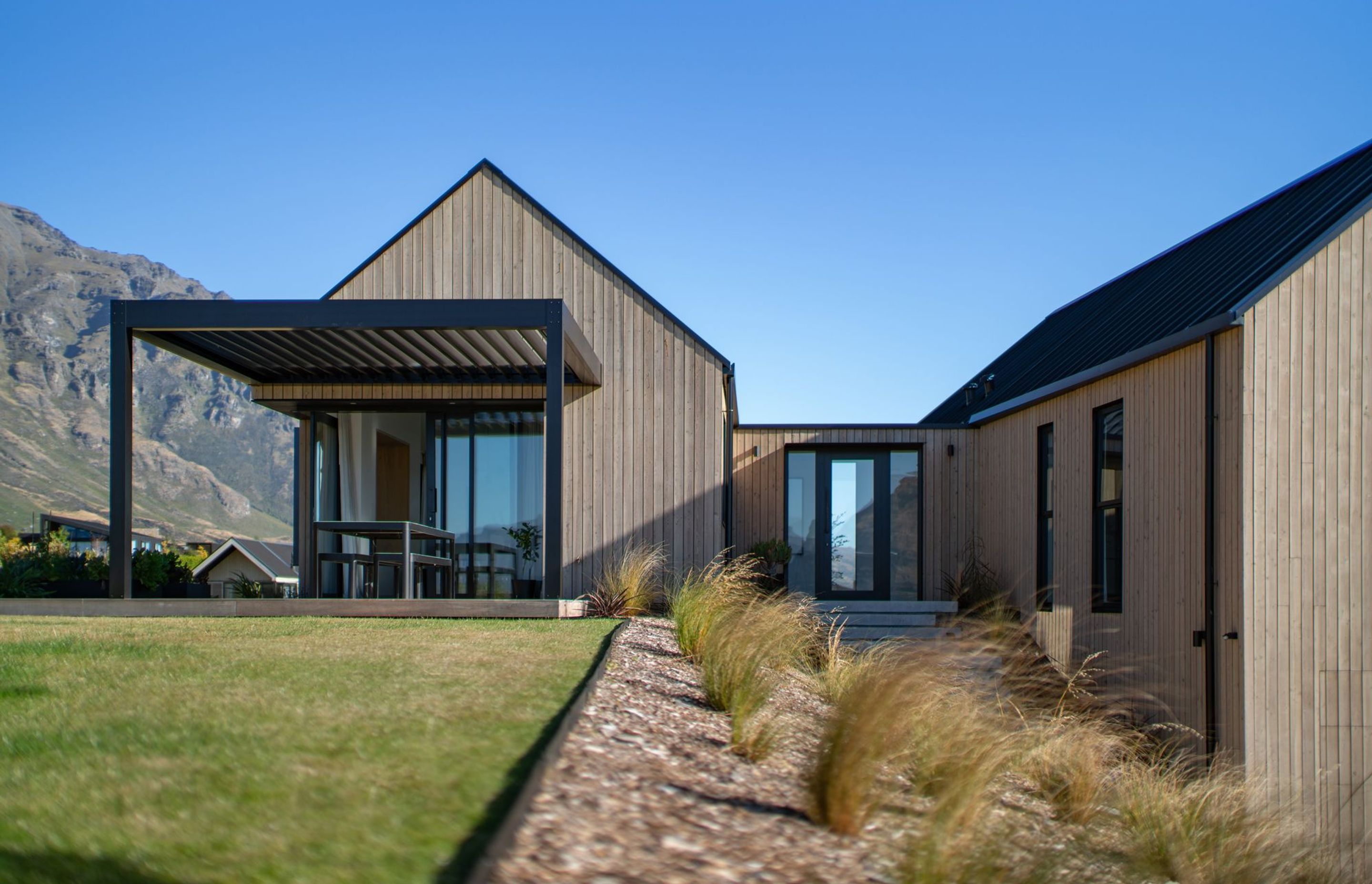 The morning sun is enjoyed from a deck spilling out form the kitchen/living space.