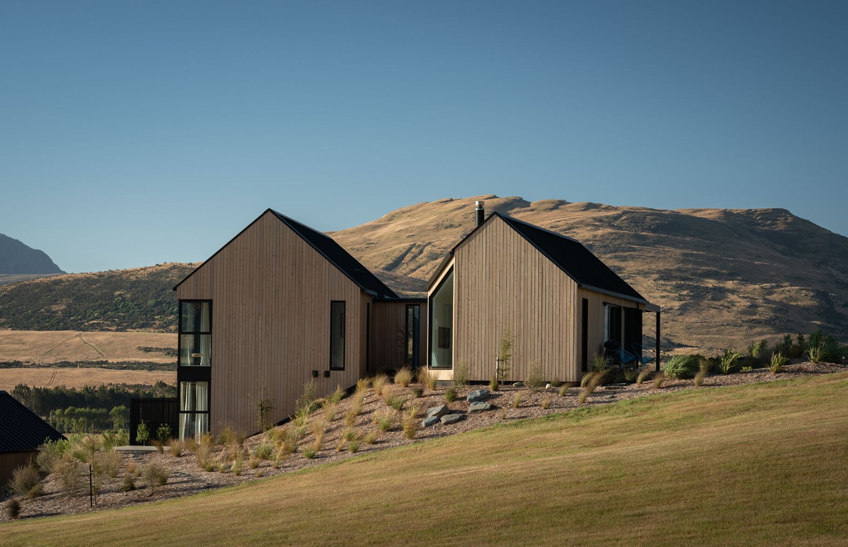 The home steps down the sloped site, which is adjacent to a public reserve.