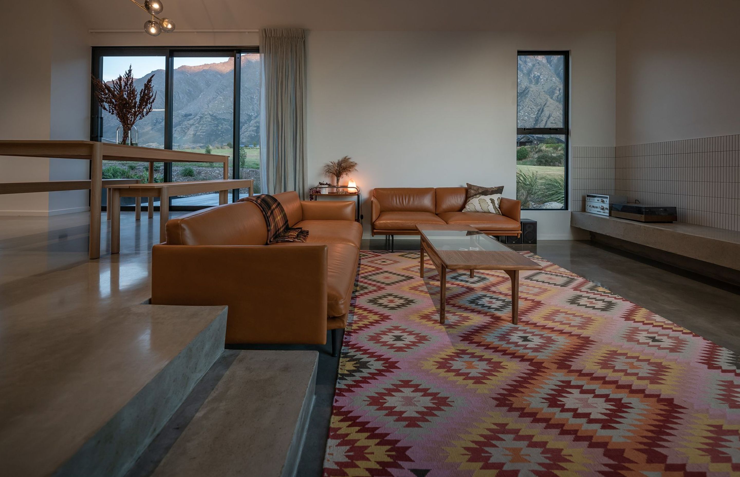 The sunken lounge is accessed through in situ concrete stairs at the rear of the dining space. An external deck at the back of the lounge is a perfect spot to catch the evening sun.