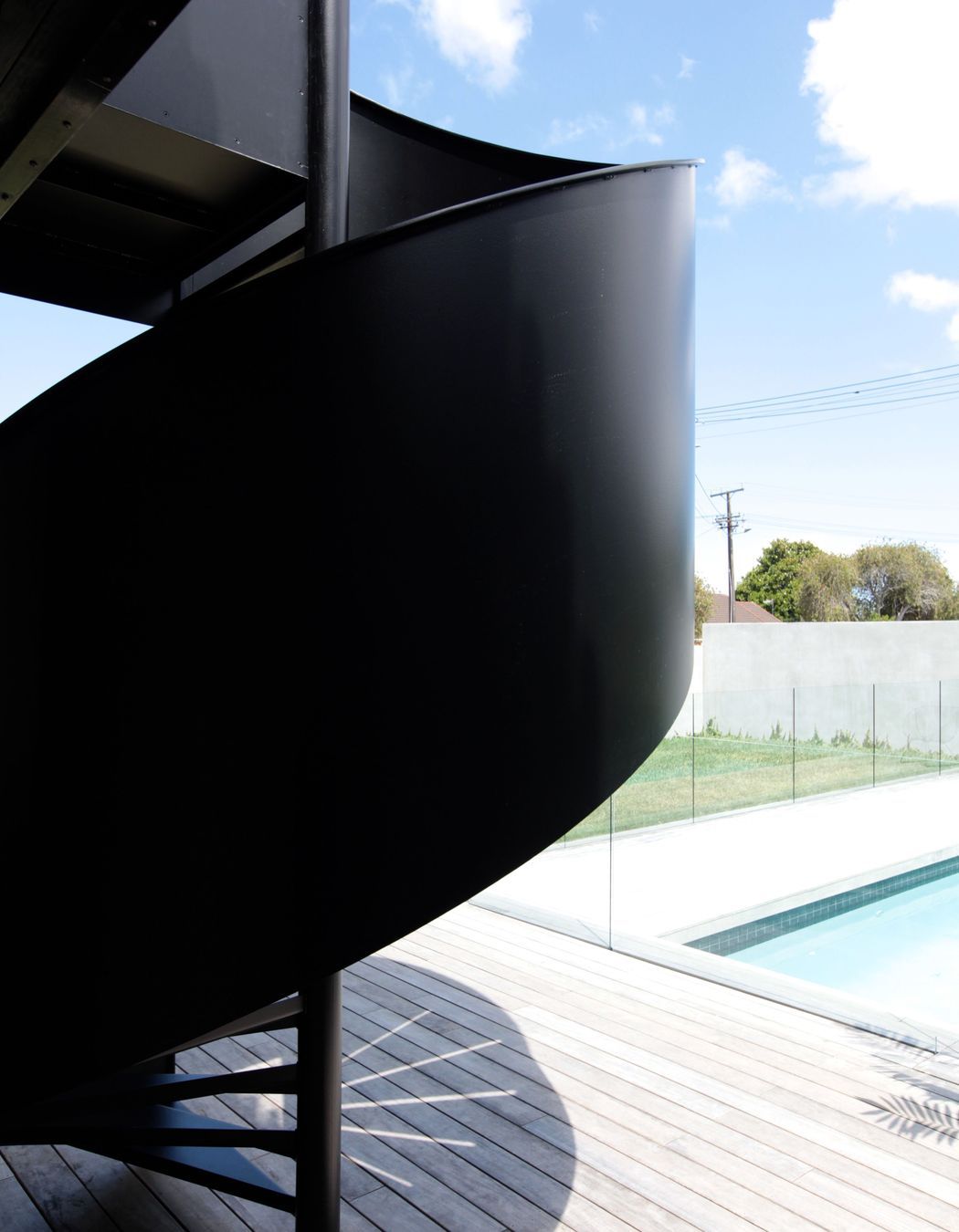 The curves of the sprial staircase serve to soften the otherwise rigid lines of the architecture.