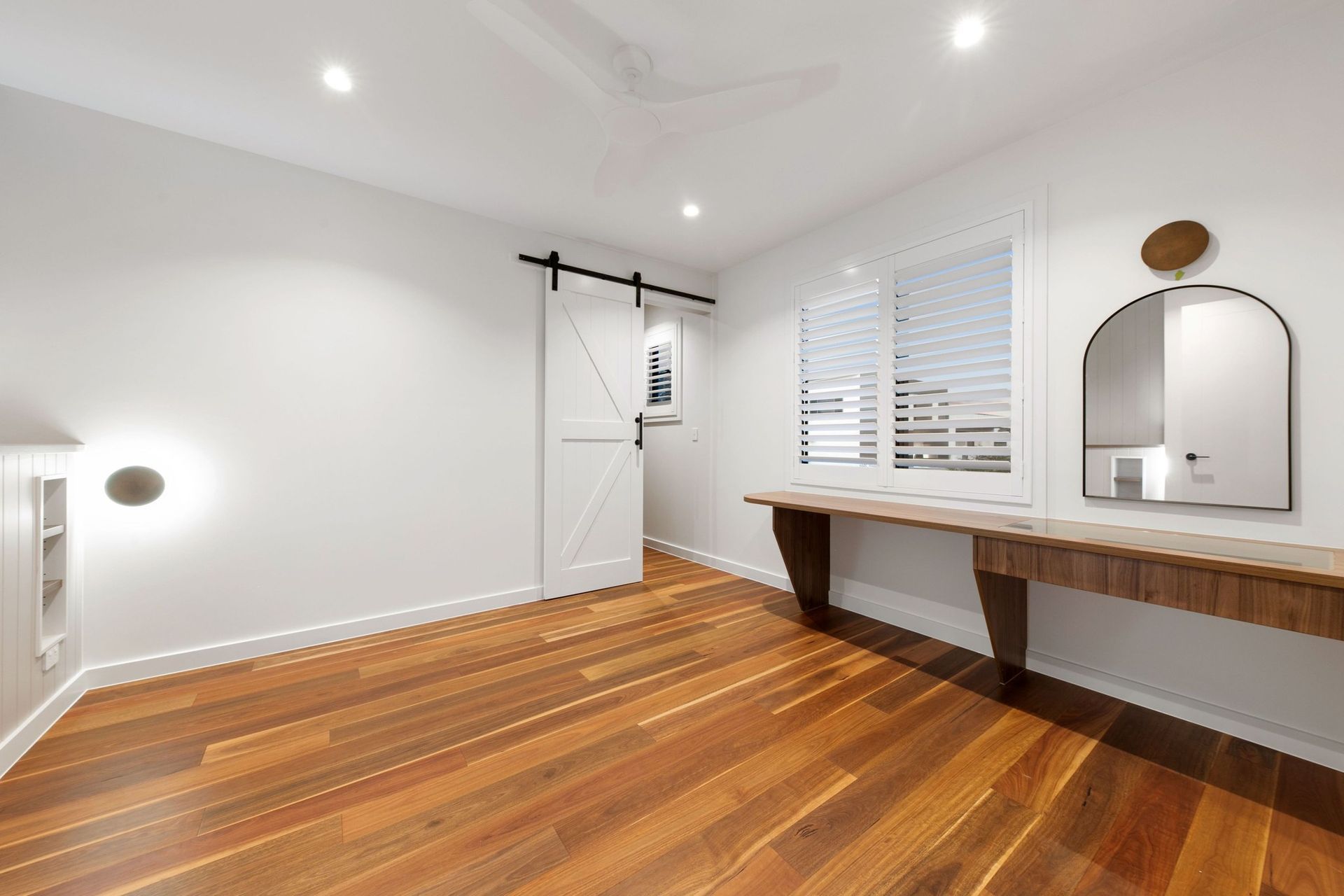 Built-in walnut joinery gives each bedroom its own study and dressing space.
