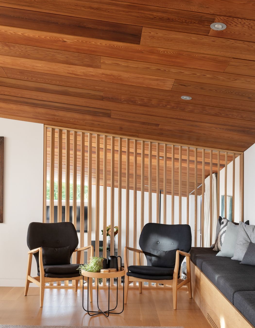Simple structural forms are elegantly positioned over tiered spatial arrangements cascading down the sloping site, pulling light into the home while also offering moments of retreat.