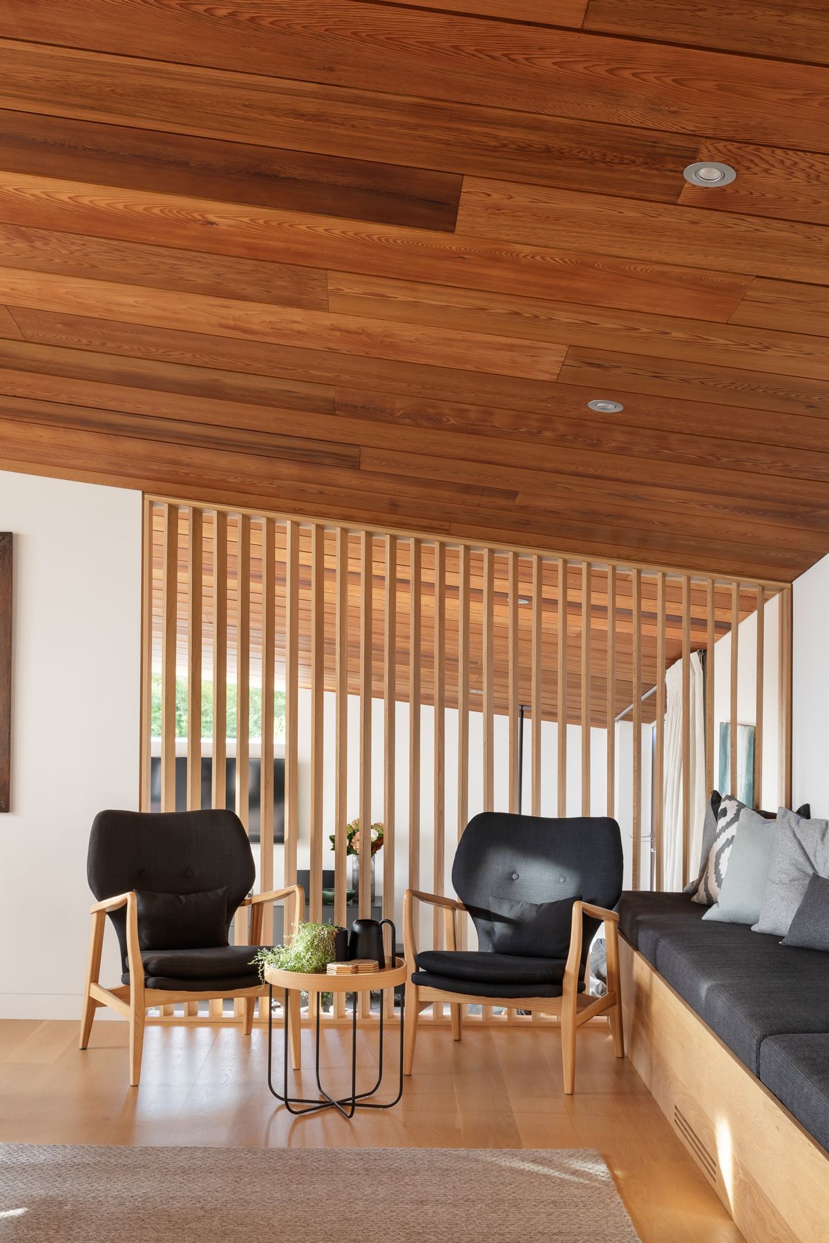 Simple structural forms are elegantly positioned over tiered spatial arrangements cascading down the sloping site, pulling light into the home while also offering moments of retreat.