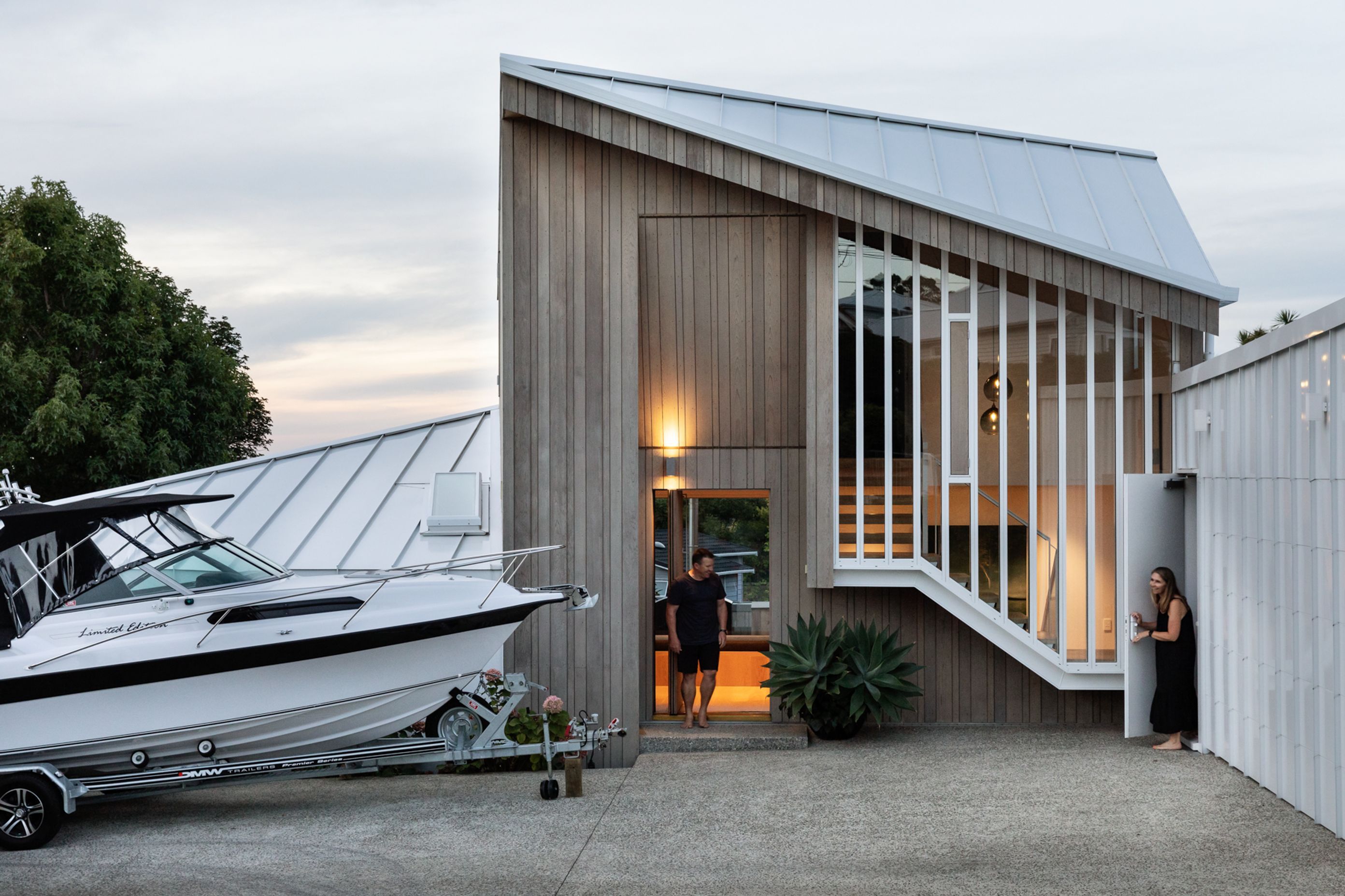 Hints of the domestic are offered via a cedar clad entry, with tall slender windows looking outwards.