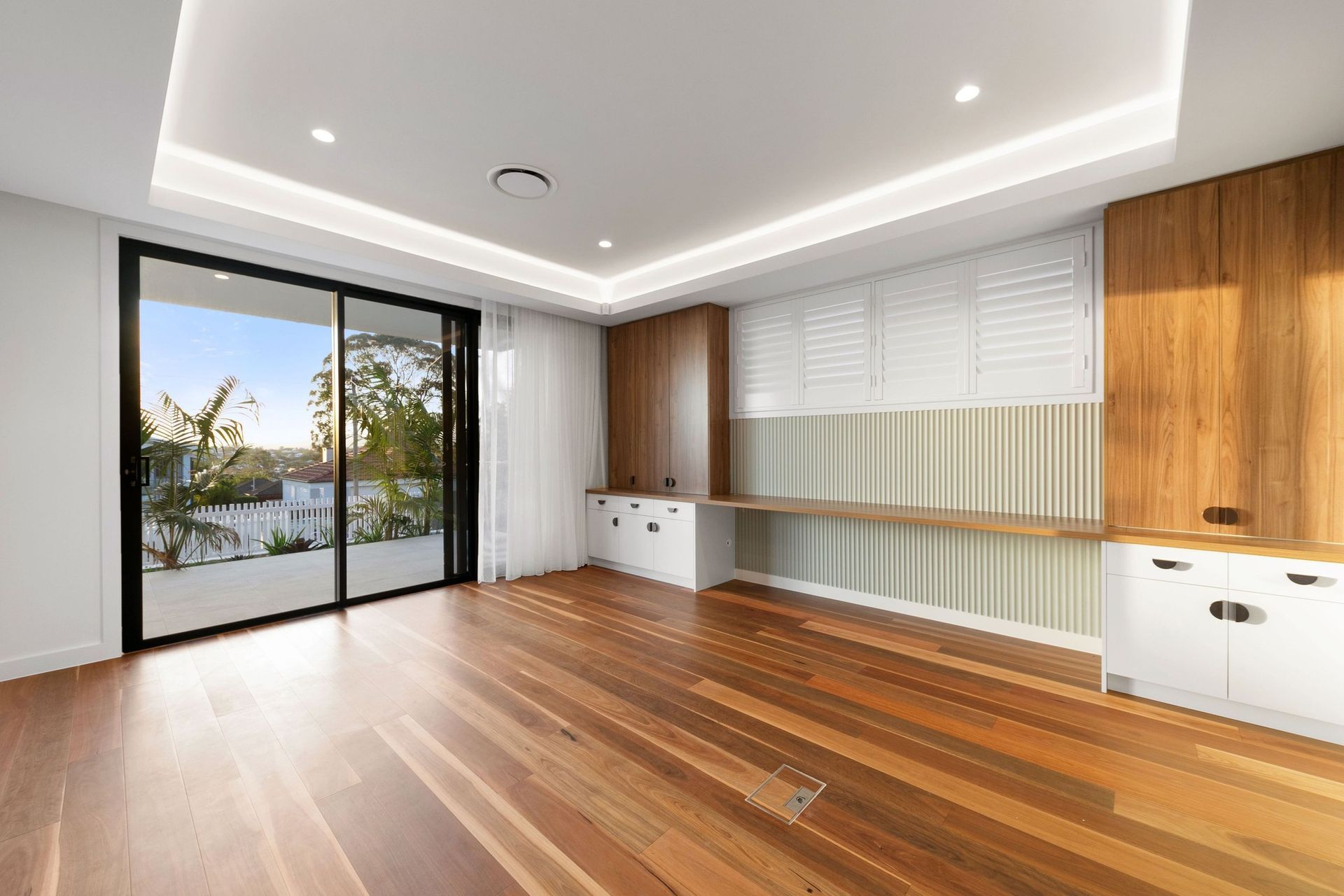 A shared study runs the length of the room, with shutters and terrace light to work by.