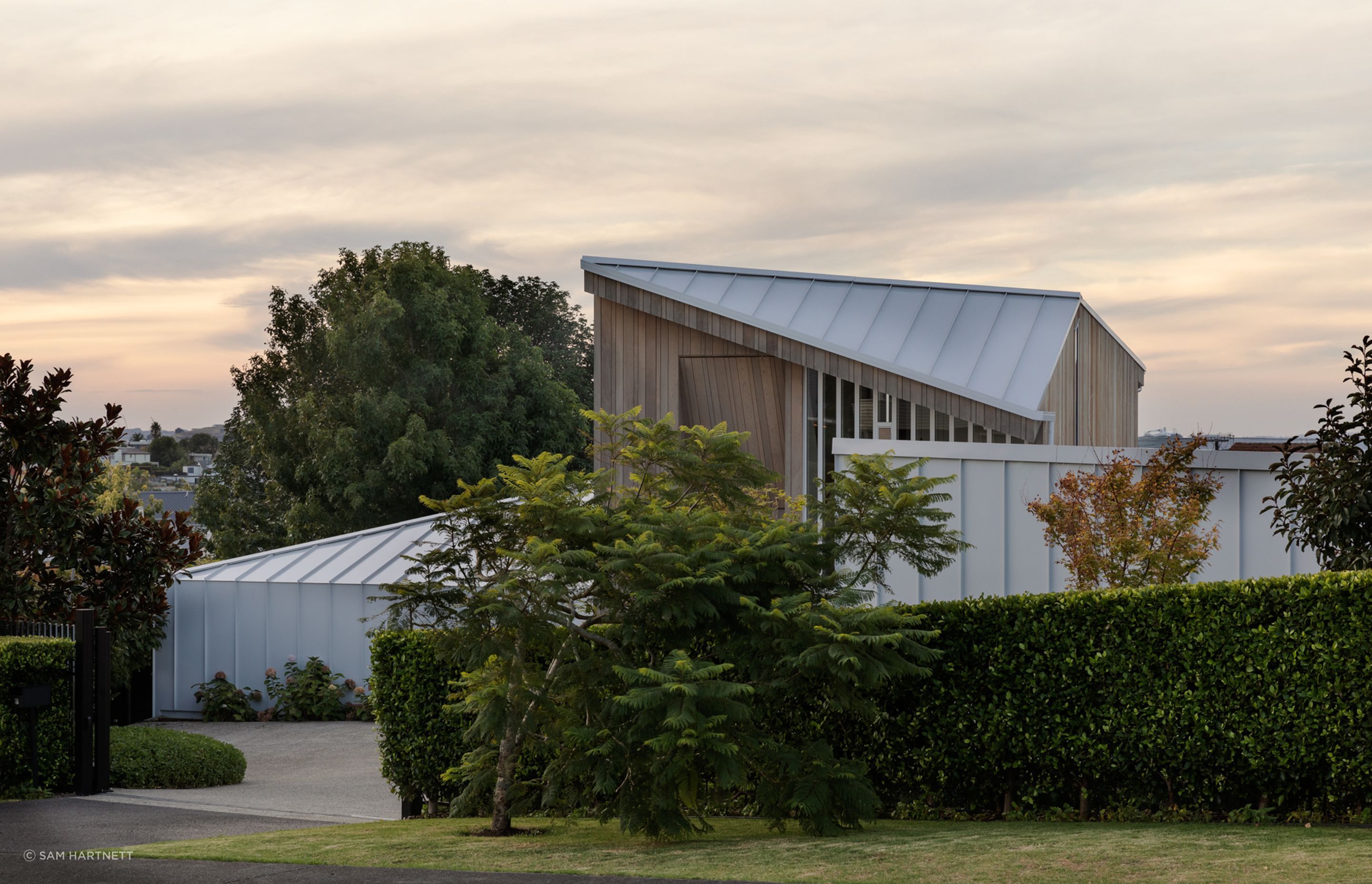 A family home that is shielded from the street by a cloak of white, shimmery amour.