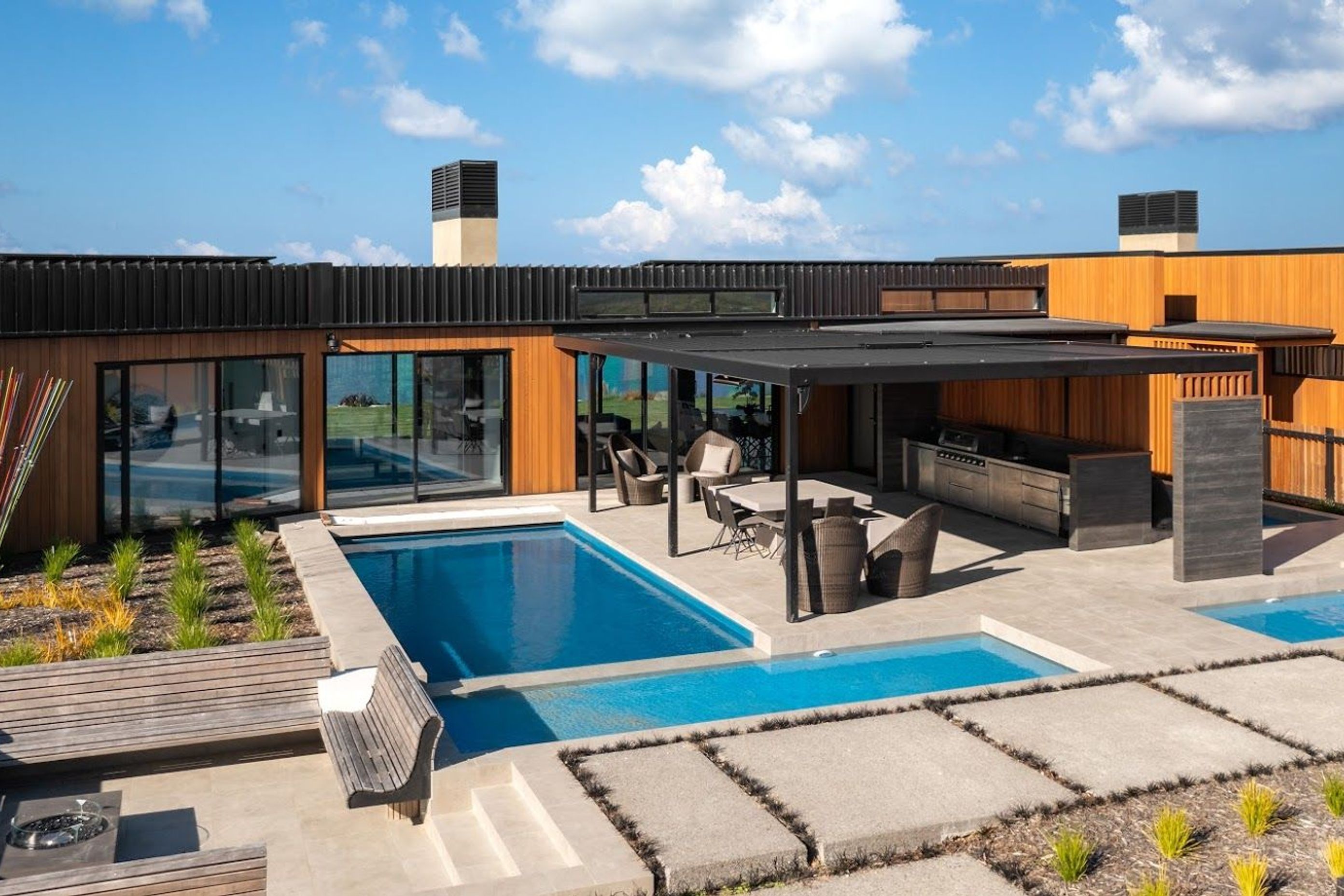 The pool area adjacent to the entry passage connects directly with the living spaces in the central module.