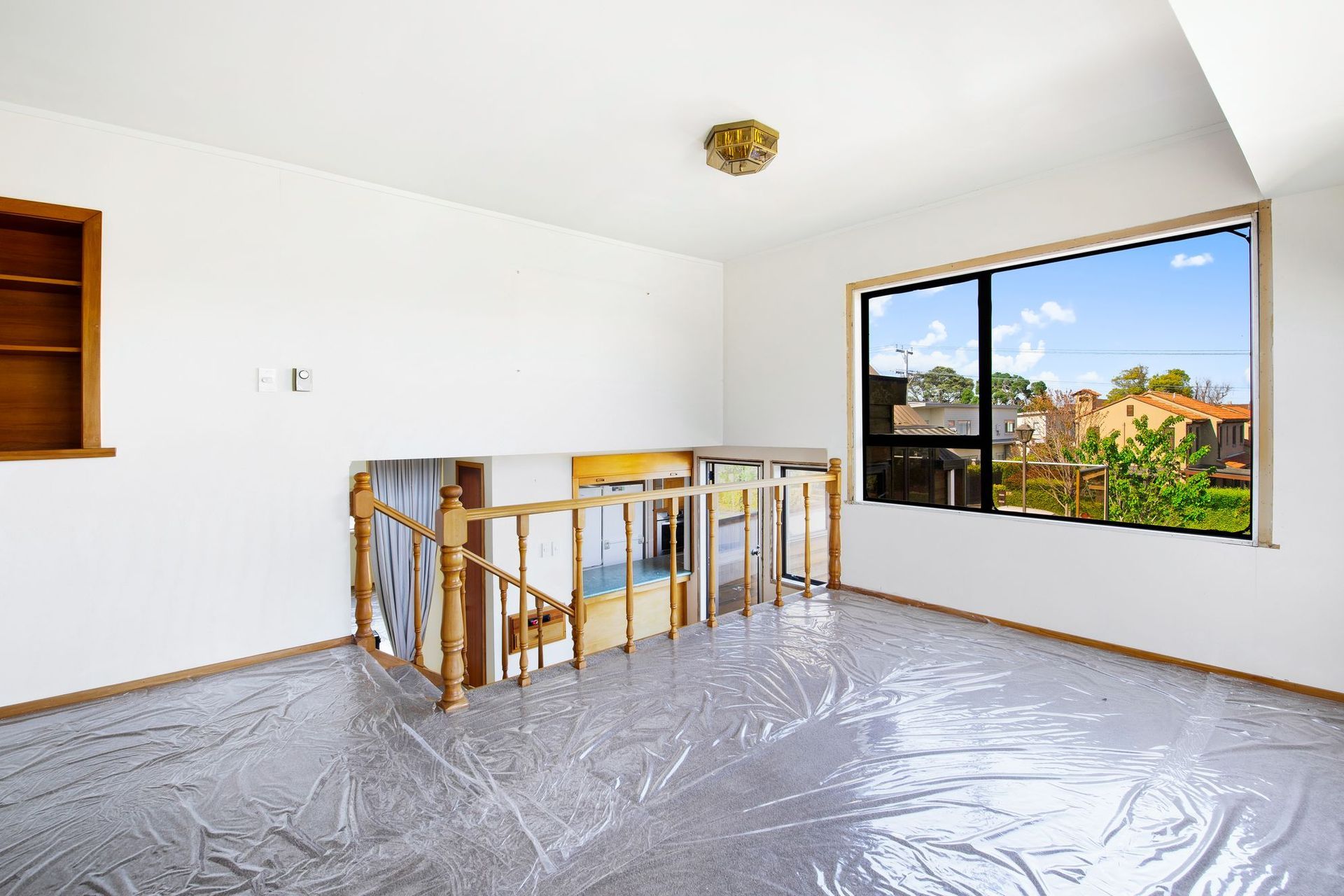 Before image of the upper-level lounge and staircase