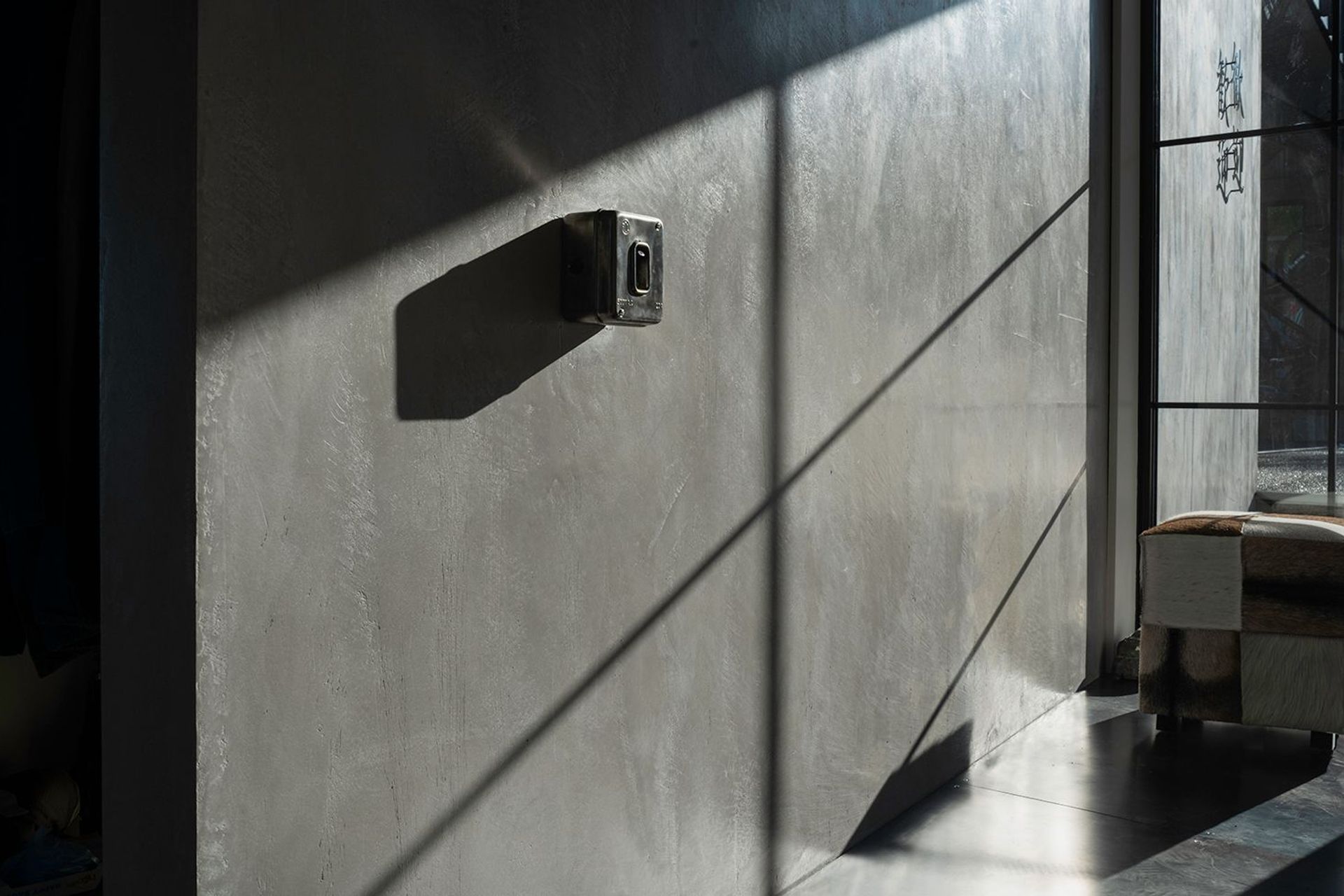 The Entrance with a hint of steampunk a second hand industrial switches on a Venetian Plaster concrete look wall.