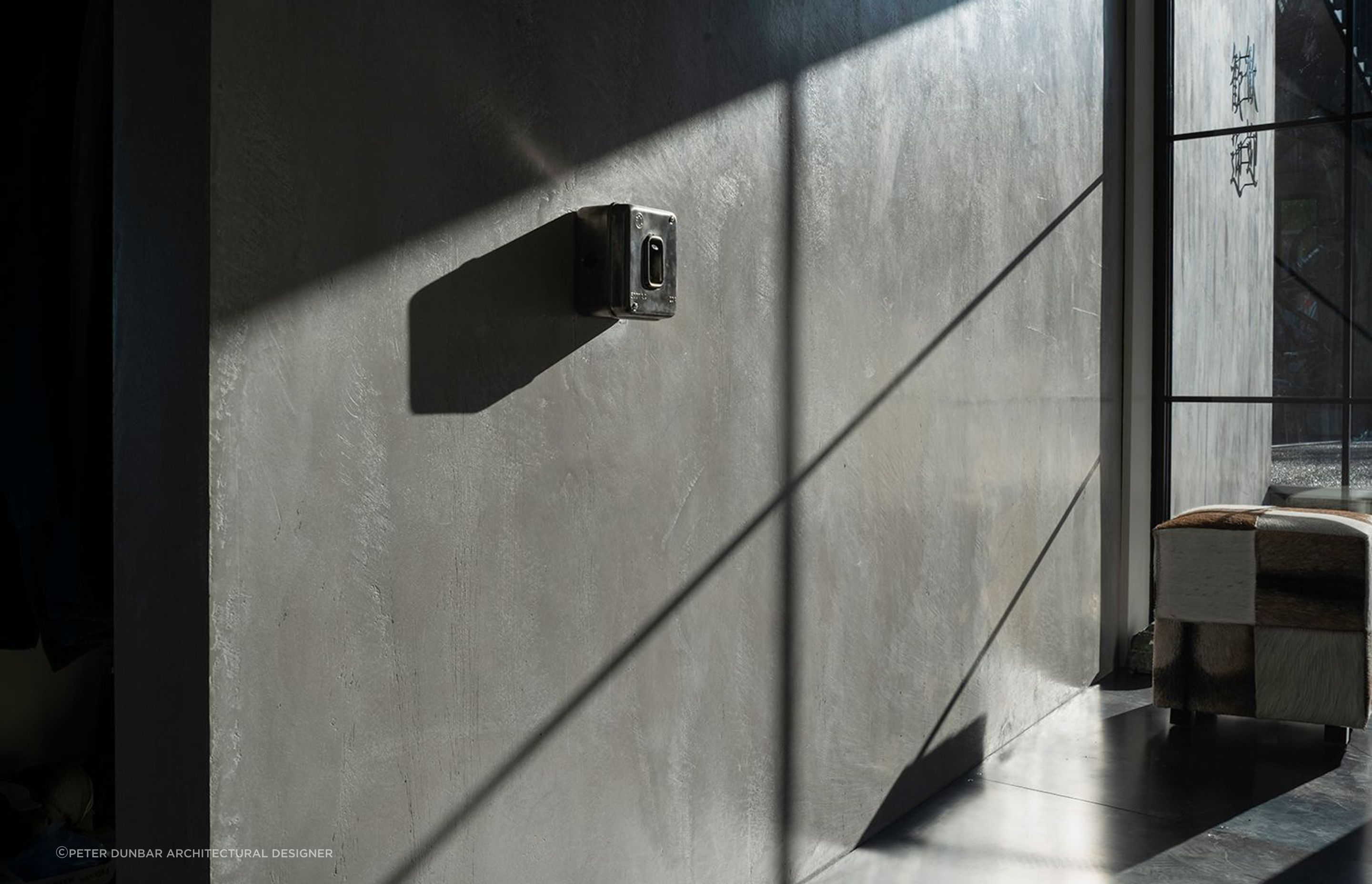 The Entrance with a hint of steampunk a second hand industrial switches on a Venetian Plaster concrete look wall.