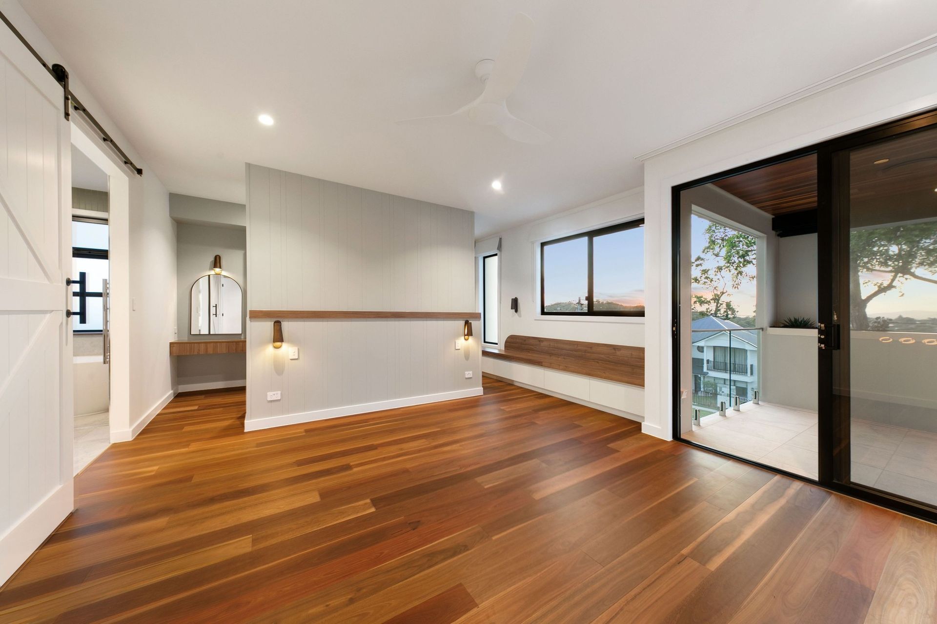 The main suite takes the view quietly — a walnut window seat and a balcony for the evening light.