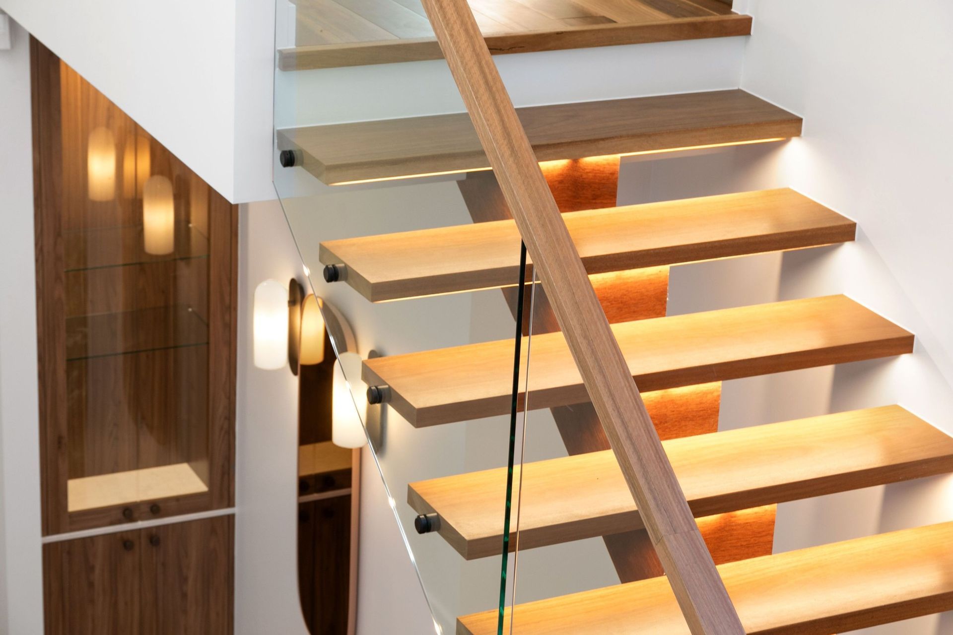 Concealed LED strips float each tread — precision joinery meeting electrical planning.