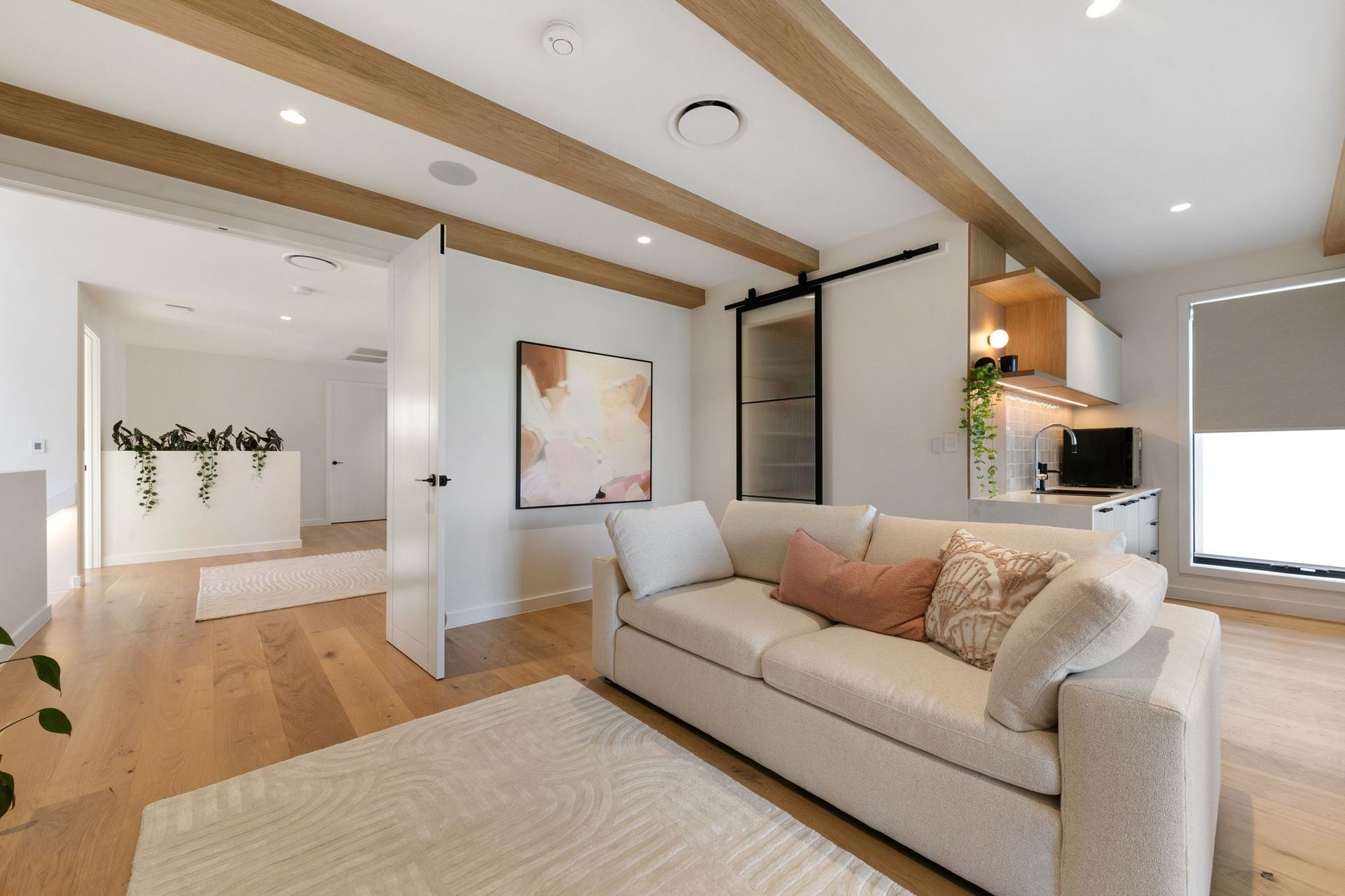 Exposed oak beams and a kitchenette make the upper living room a retreat of its own.