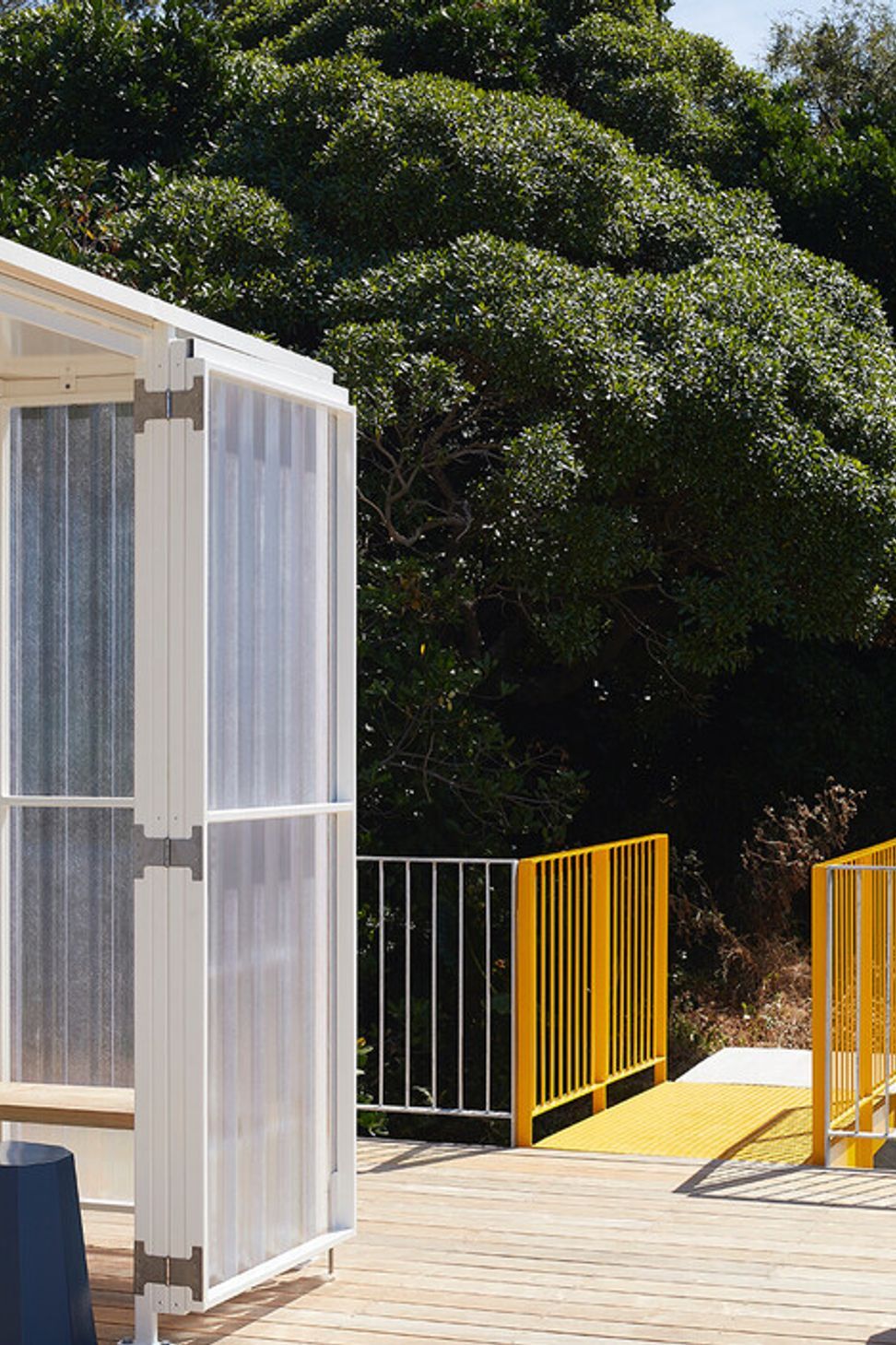 The yellow metal bridge provides access to the roof deck.