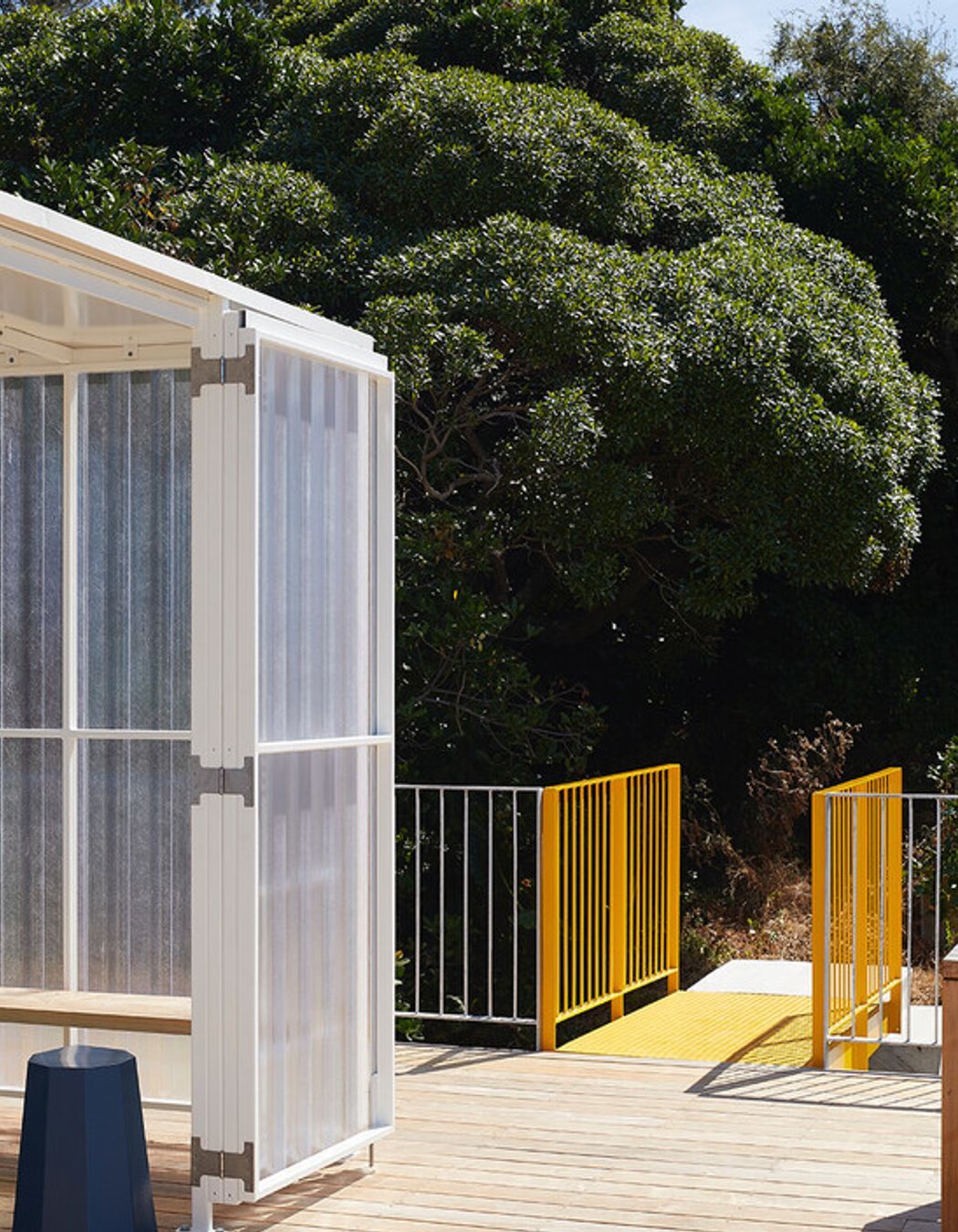 The yellow metal bridge provides access to the roof deck.