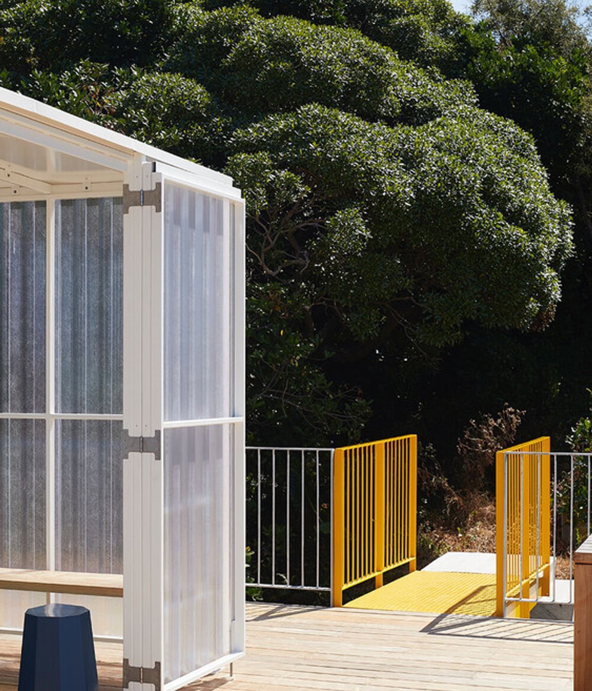 The yellow metal bridge provides access to the roof deck.