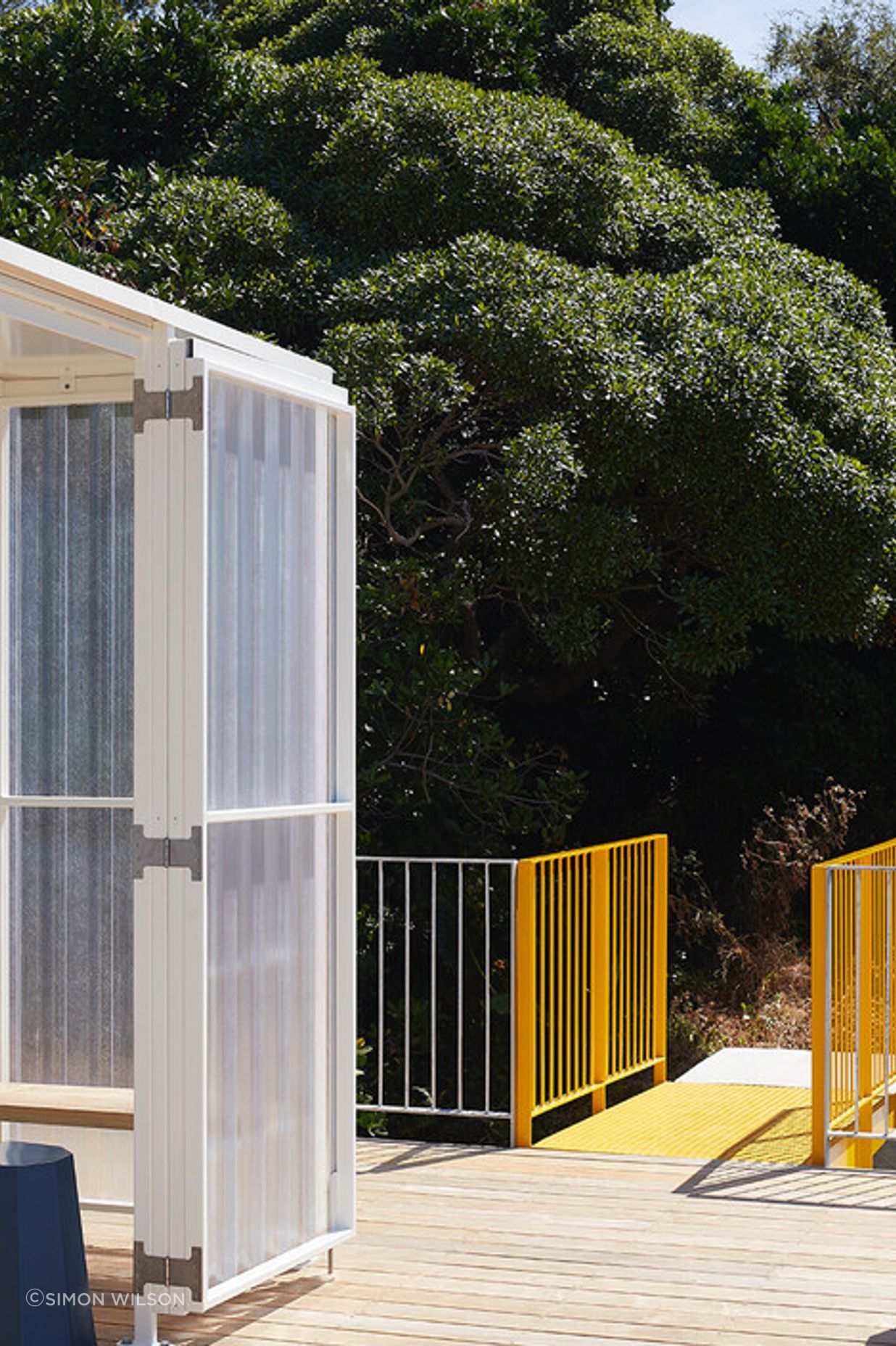 The yellow metal bridge provides access to the roof deck.