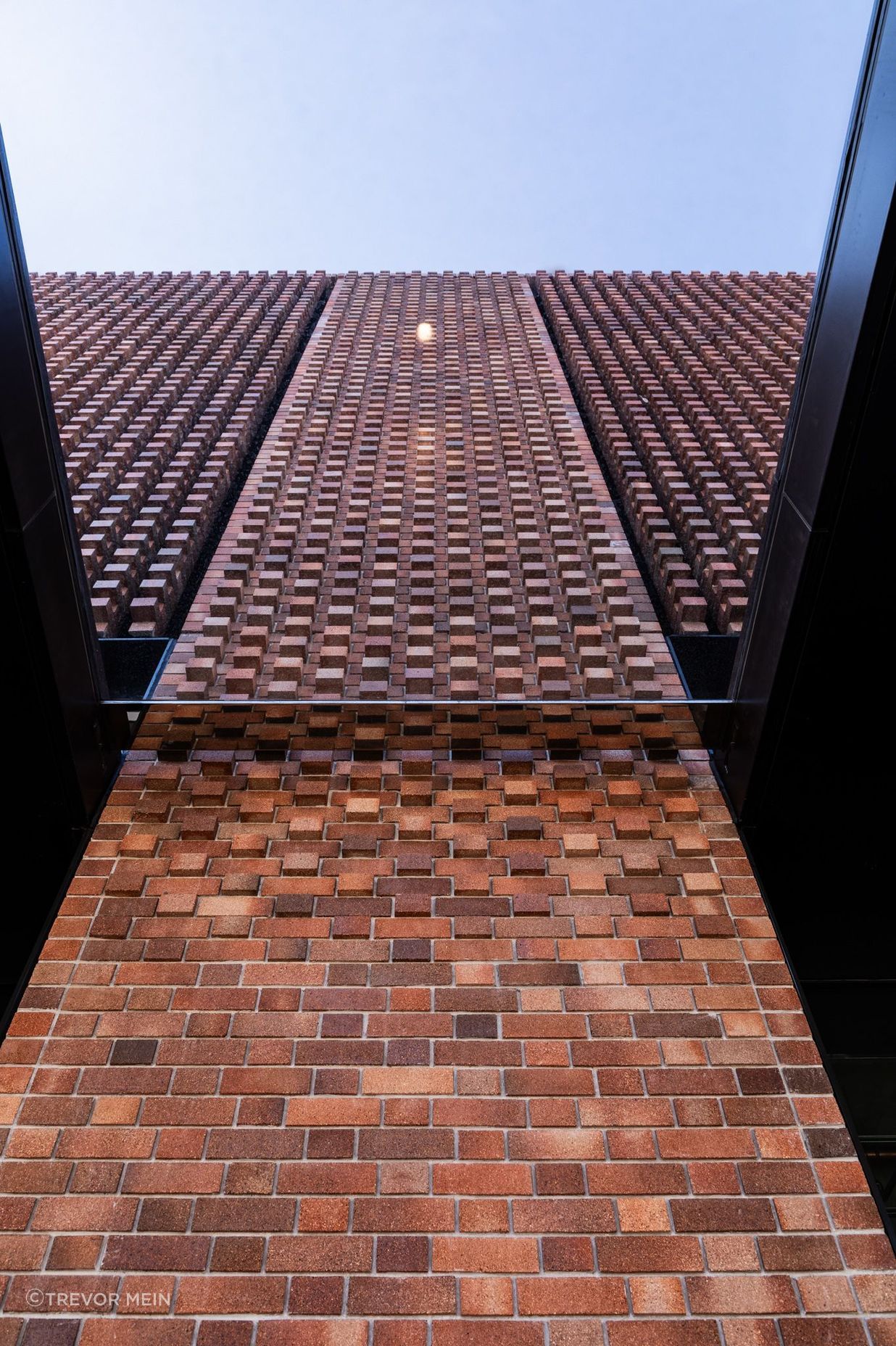 Brick louvers, or hit and miss columns of brickwork, alternate with the Brick Inlay panels, allowing 50% of the facade to be ventilated