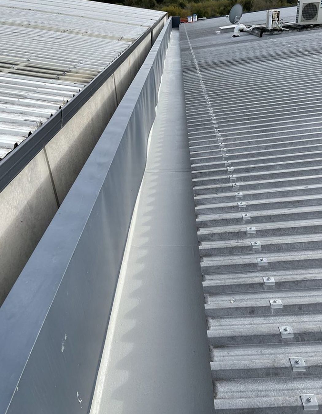 Liquid membrane system applied over existing membrane to internal box gutter