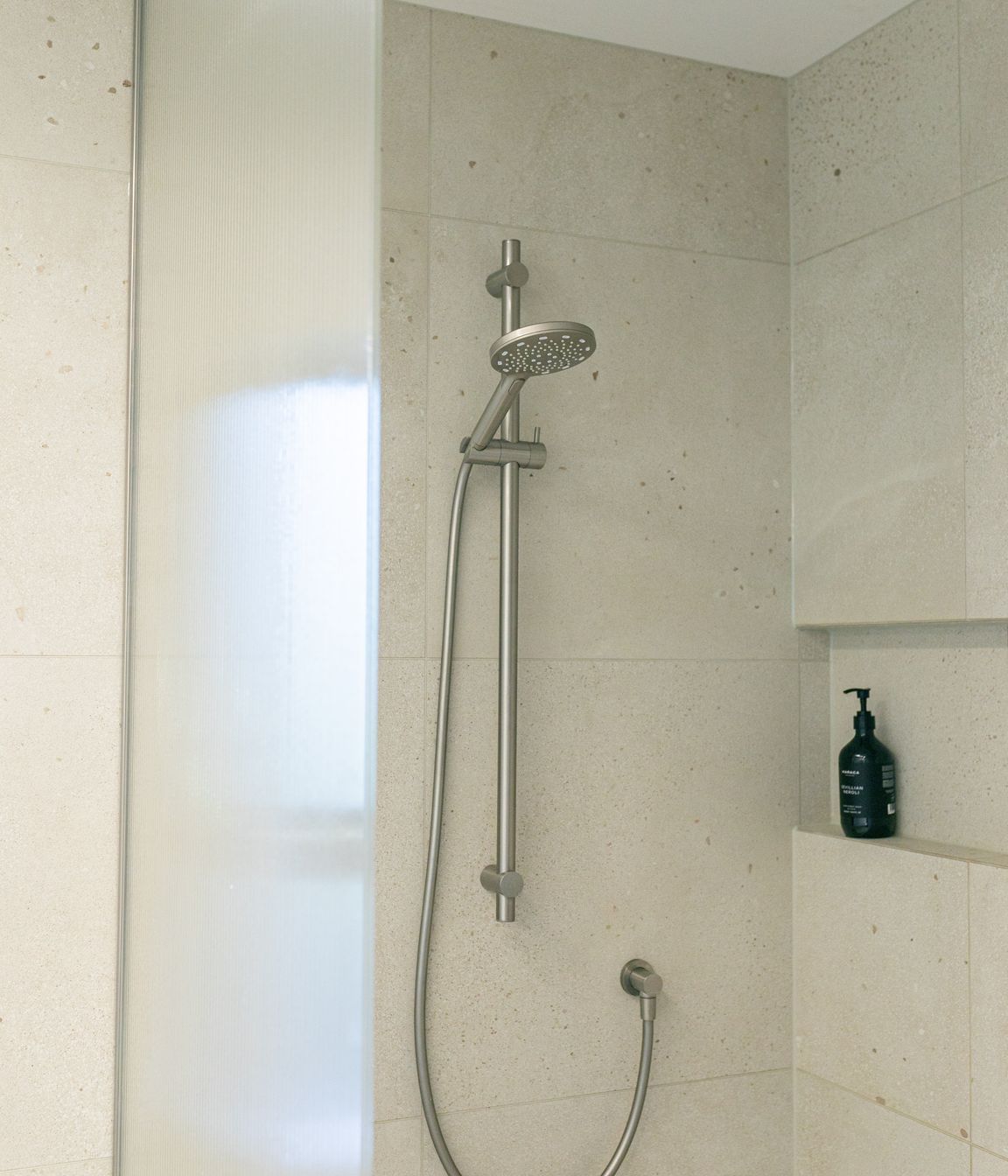 Texture and neutral colours combine in the shower spaces.