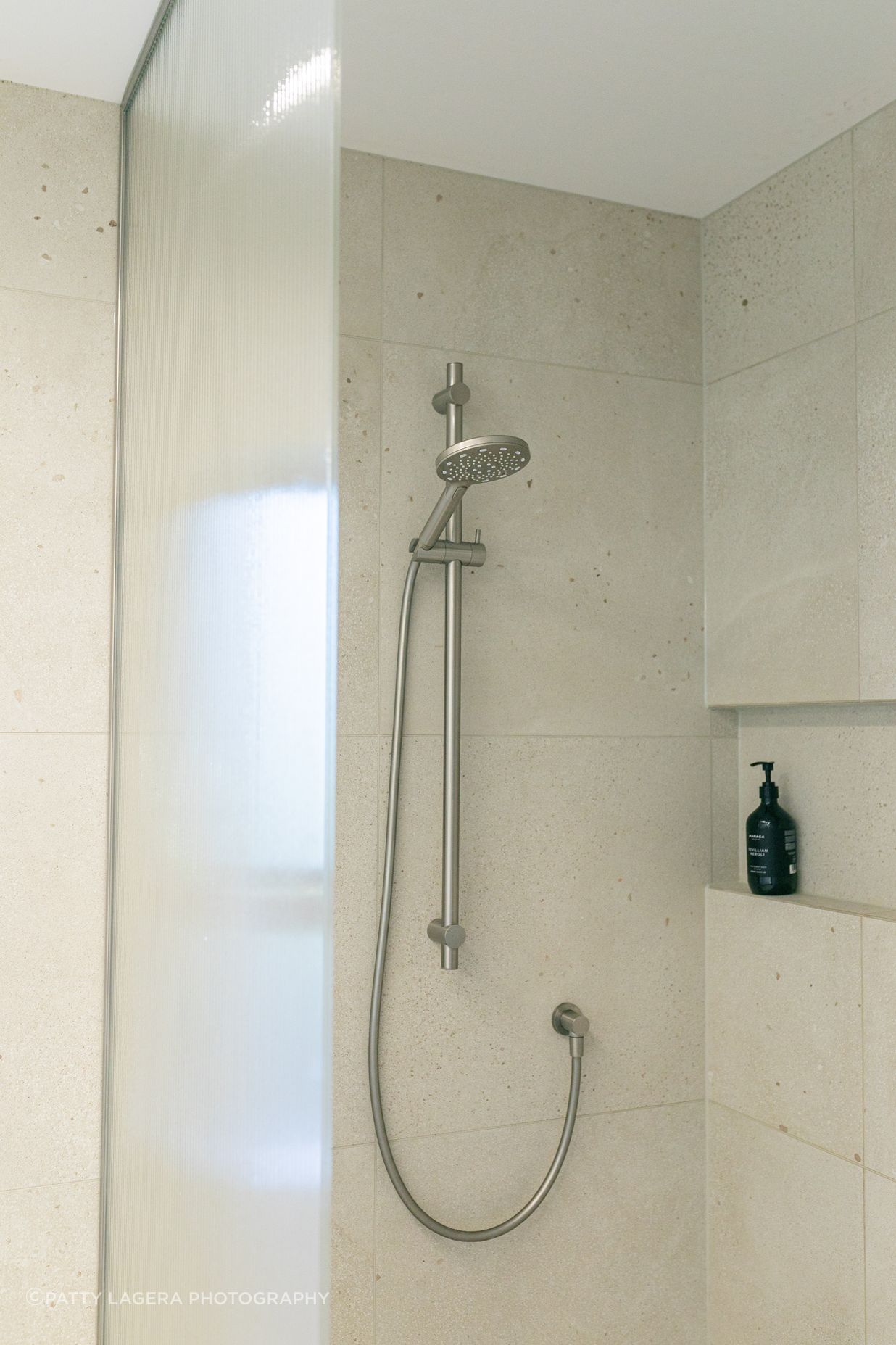 Texture and neutral colours combine in the shower spaces.