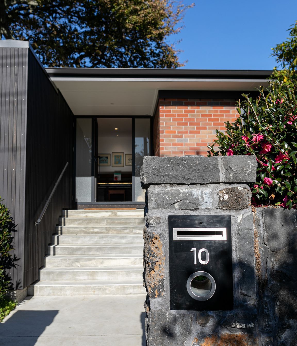 The contrast of old and new is experienced from the front of the dwelling.
