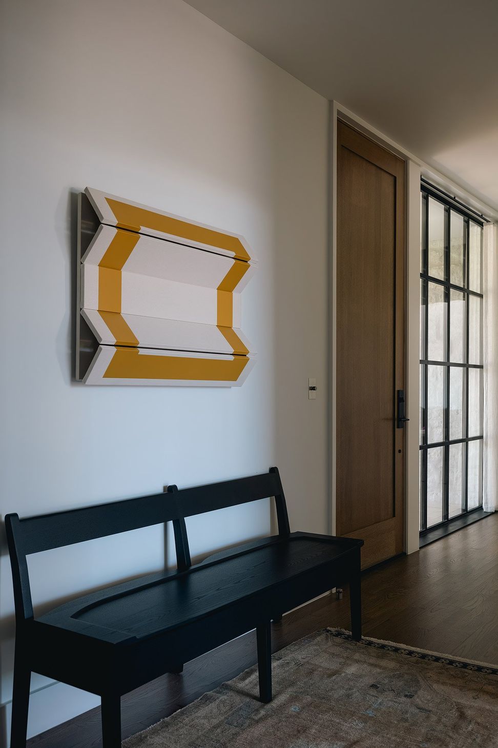 12RollingWoodCuppettKilpatrickArchitectureandInteriorDesignmodern-entryway-design-geometric-wall-art-wooden-flooring.jpg