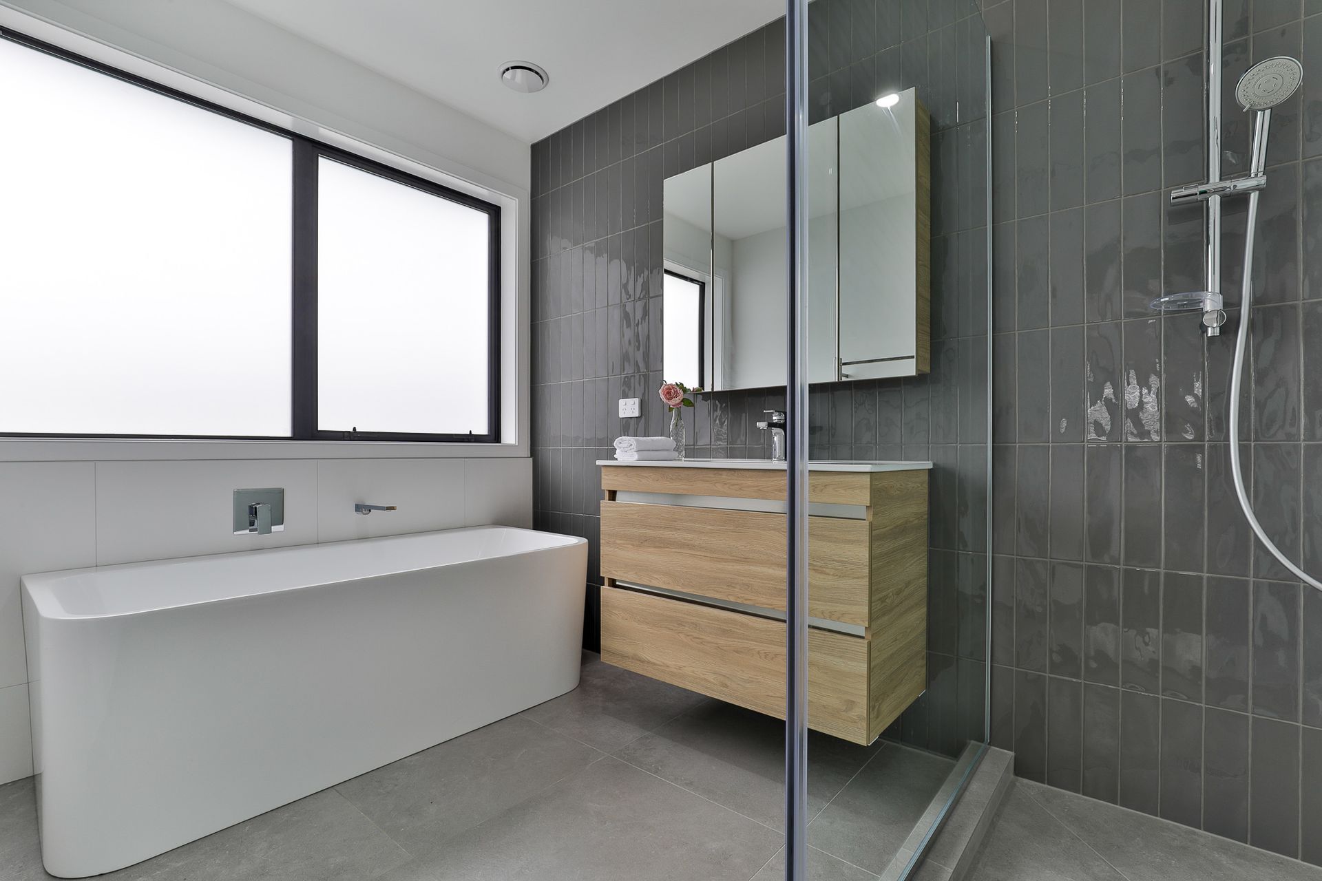 Main Bathroom: Super White Matt 600x600mm and Touch Graphite 75x300mm on walls with Lusso Pearl 600x600mm floors