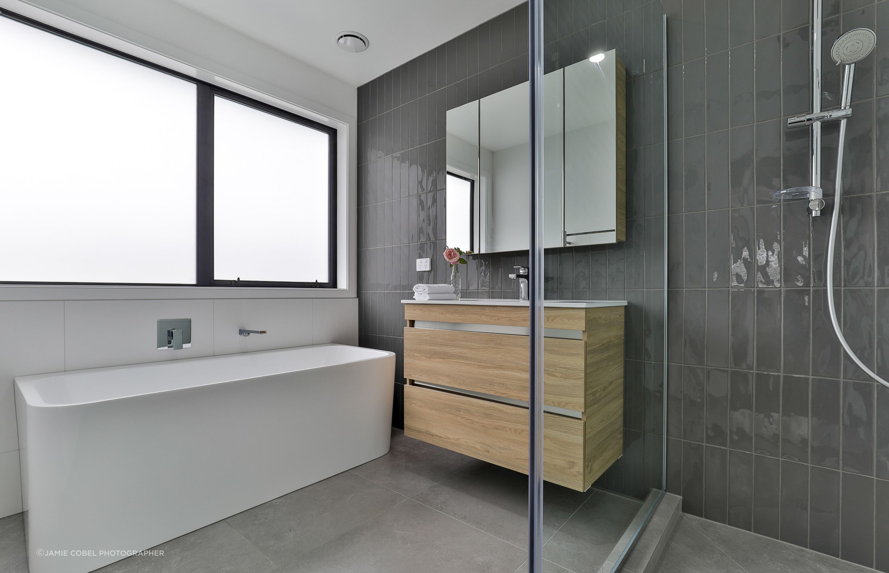 Main Bathroom: Super White Matt 600x600mm and Touch Graphite 75x300mm on walls with Lusso Pearl 600x600mm floors