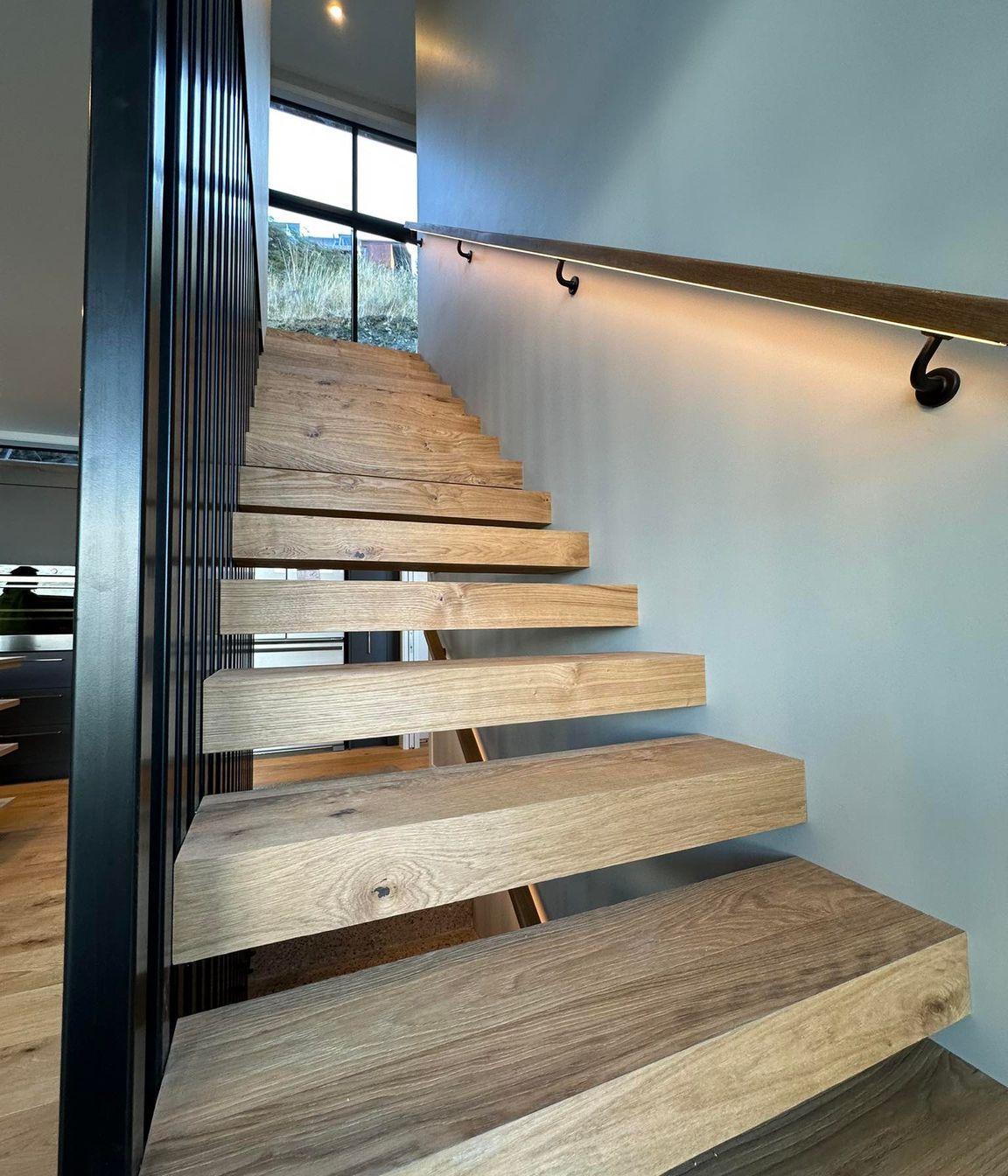 Floating internal stairs wrapped in Haro Oak flooring