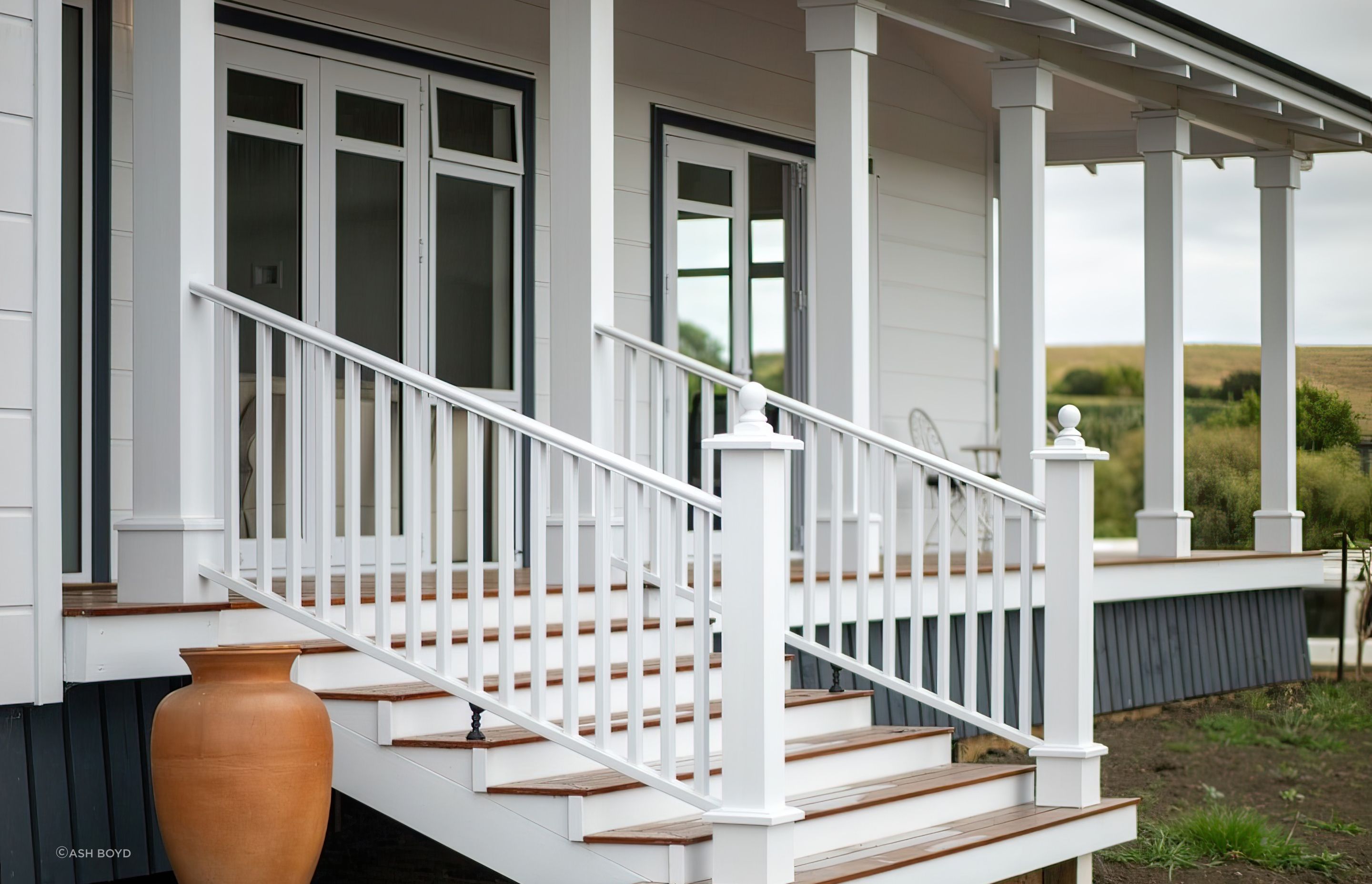 White-colonial-look-stairs-and-verandah-pillars-arcline-architecture-topaz-very-compressed-2x.jpeg