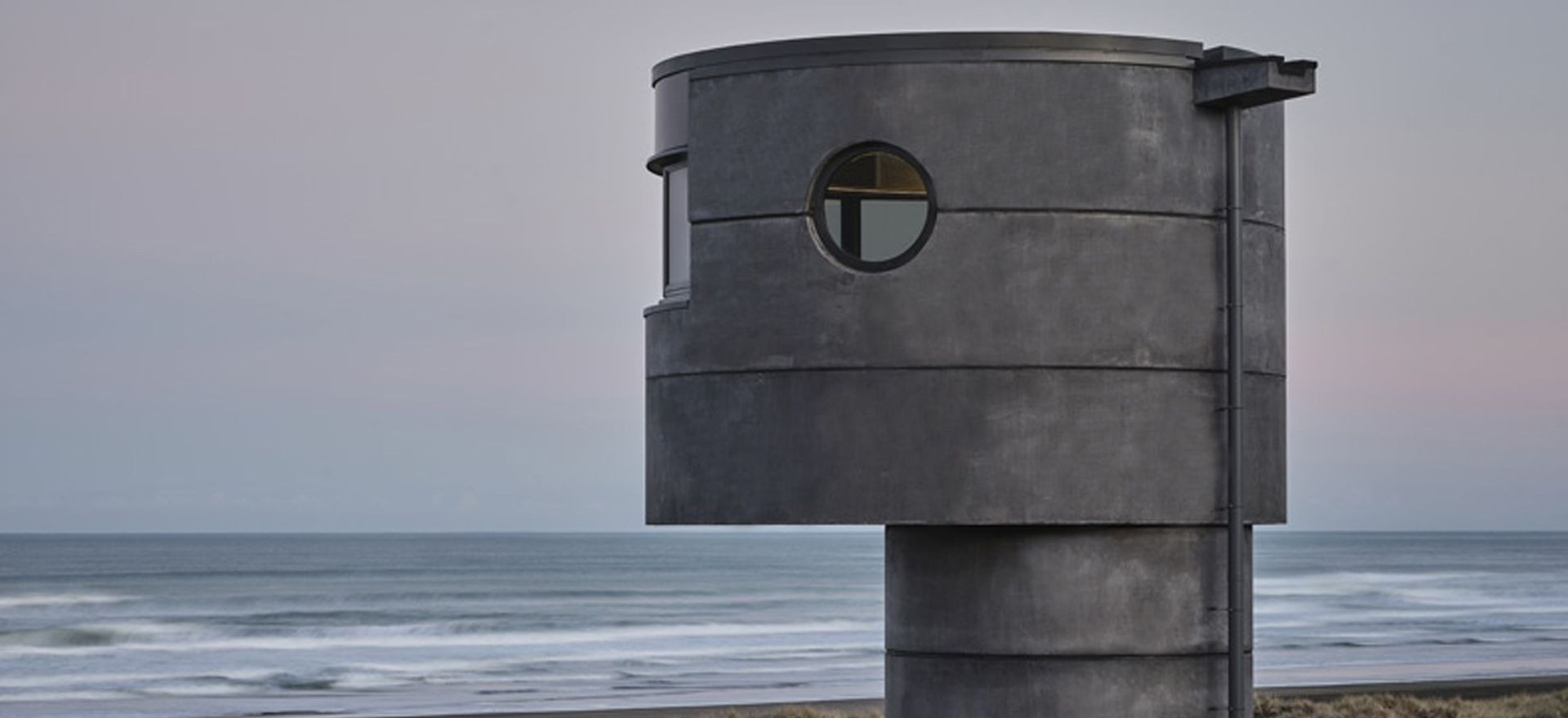 Reflections of Aotearoa: PeterFell's darkest concrete oxide finds its match on North Piha Beach