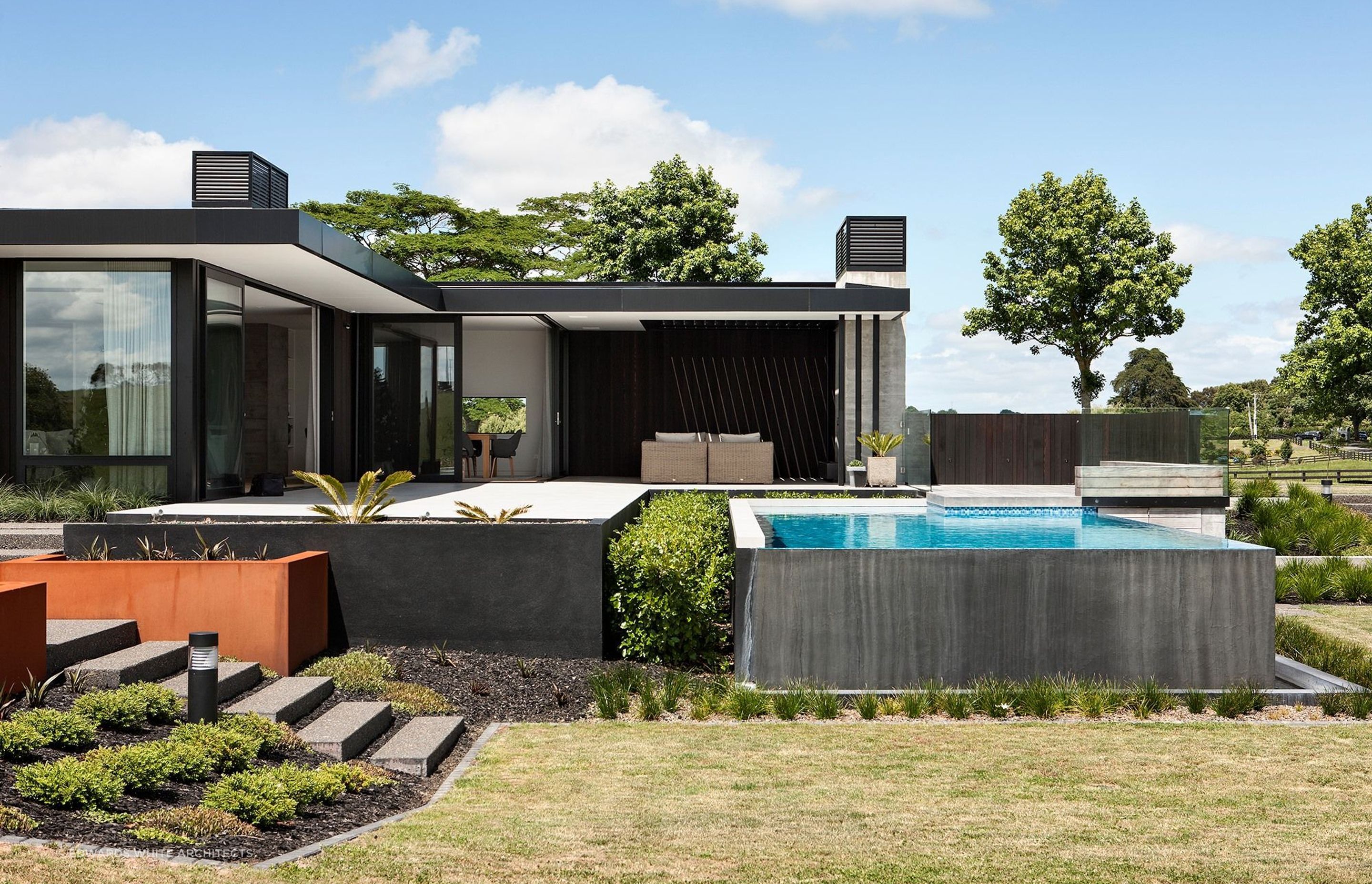 An outdoor living space featuring a lavish swimming pool.