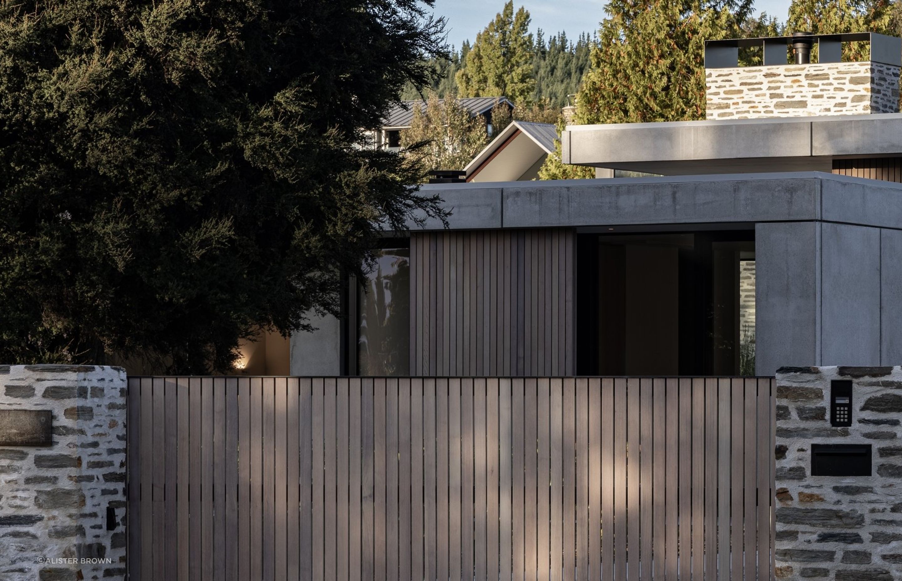 Beacon Point Road is dotted with homes, but Koroa House's protective form and material palette curate a sense of privacy.